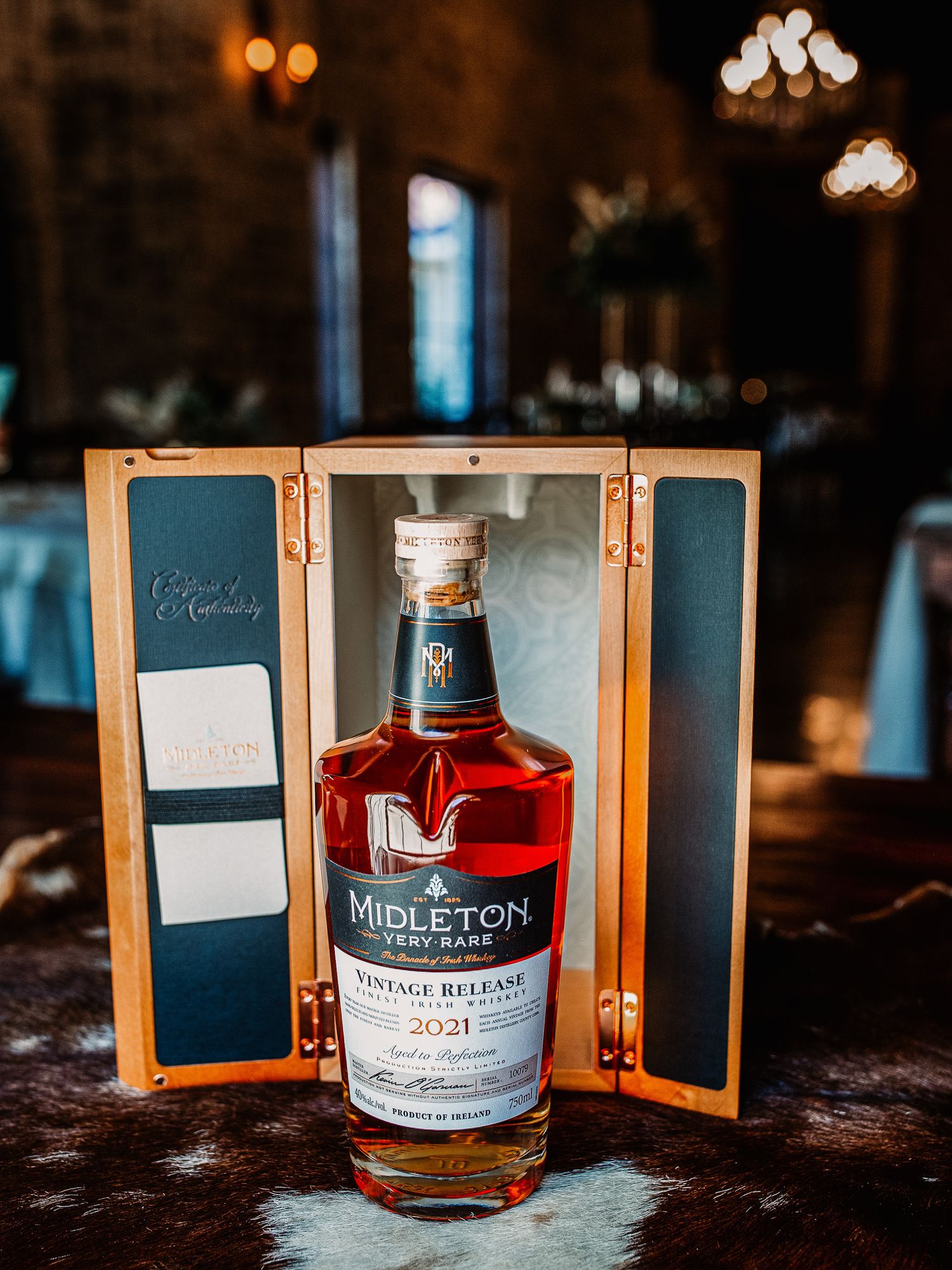 Bottle of Midleton Very Rare Irish whiskey displayed in wooden presentation case.
