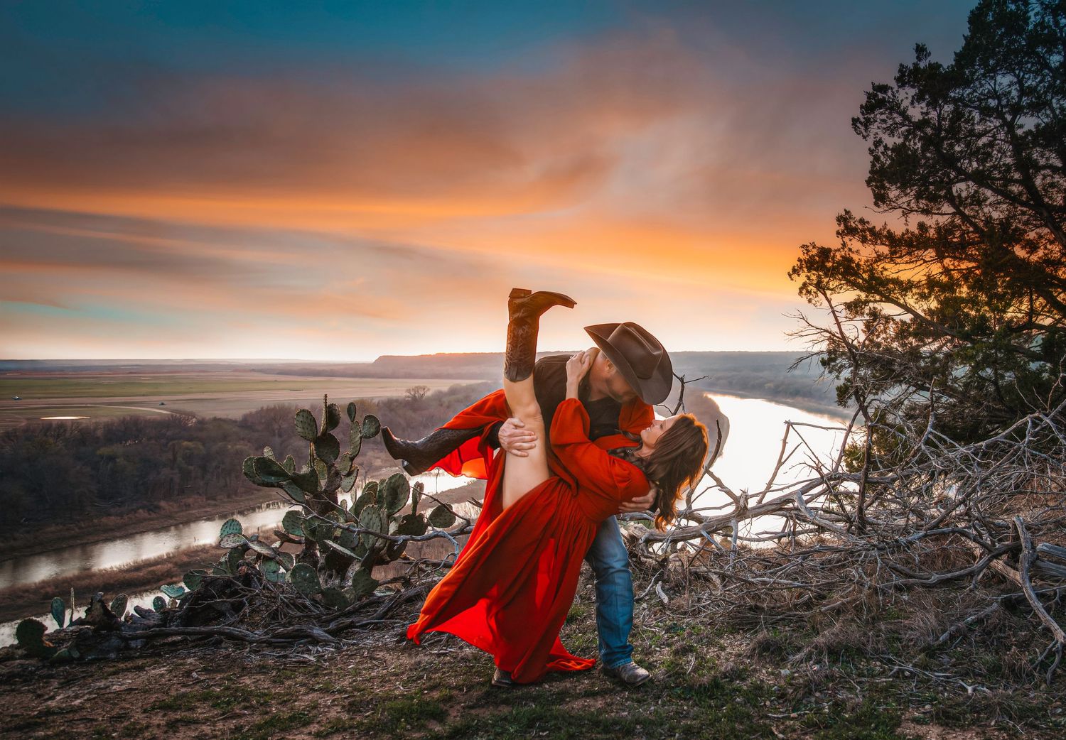 Dramatic sunset landscape series with red dress flowing in the wind against mountain backdrop.