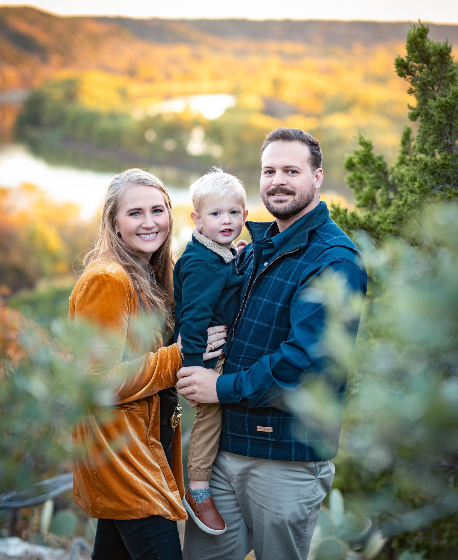 Family lifestyle session during sunset with mountains and autumn colors in background.