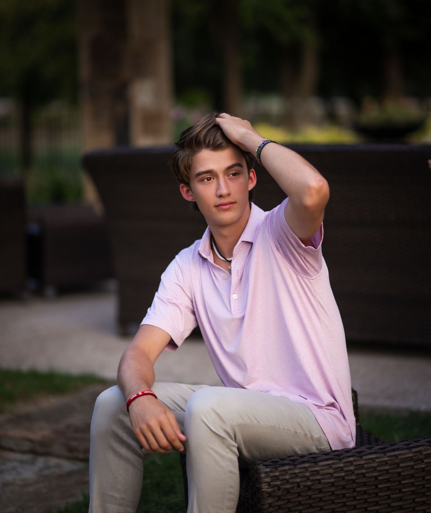 A series of casual outdoor portraits featuring a pink polo shirt and khaki pants.