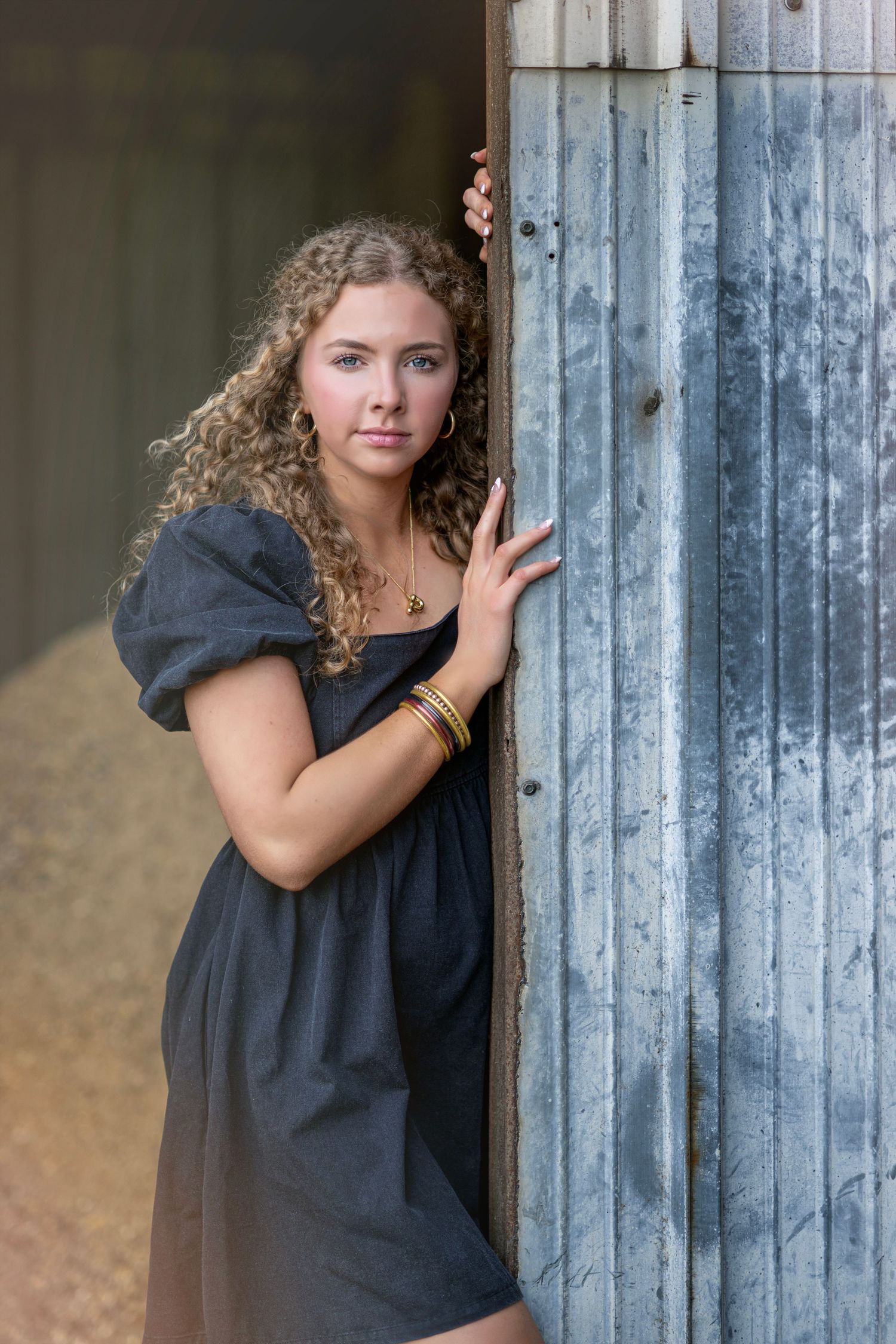 Vintage-styled portrait sequence against weathered metal siding in dramatic lighting.
