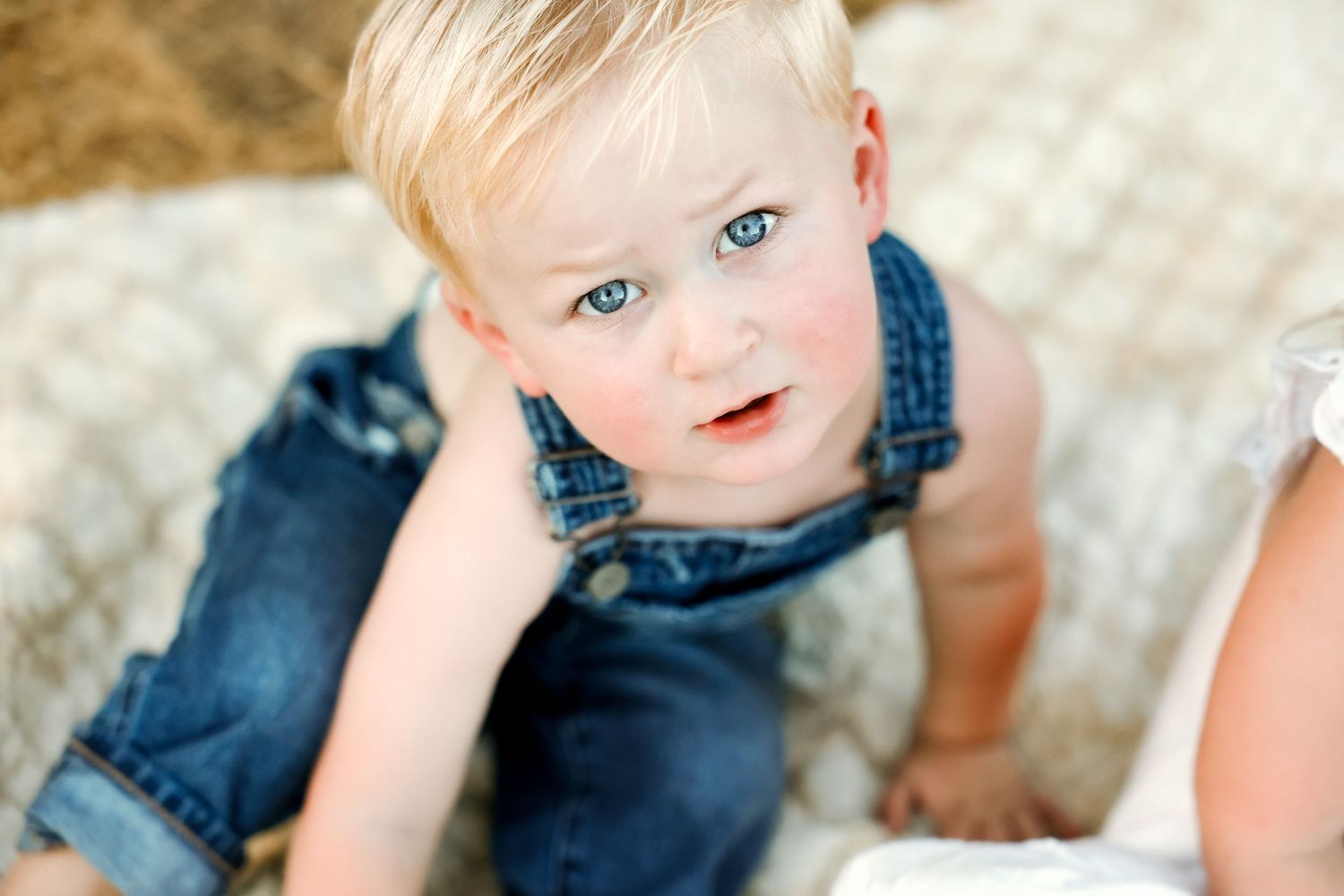 Denim overalls against soft natural lighting in an outdoor setting.
