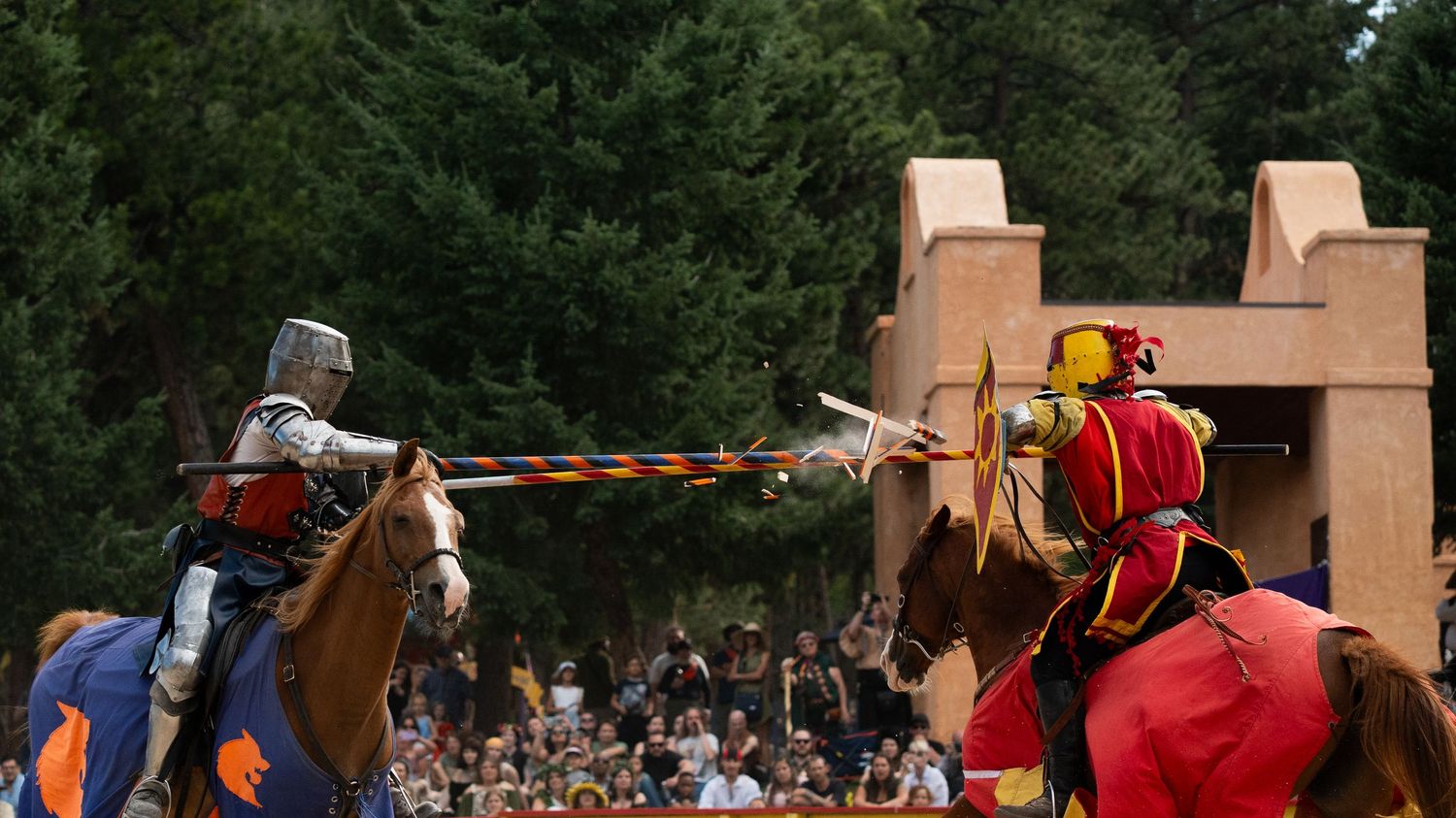 Medieval knights jousting on horseback at a renaissance festival performance.