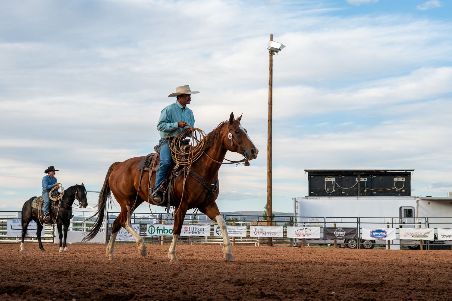 Two cowboys on horseback at a rodeo in Southeast Wyoming.