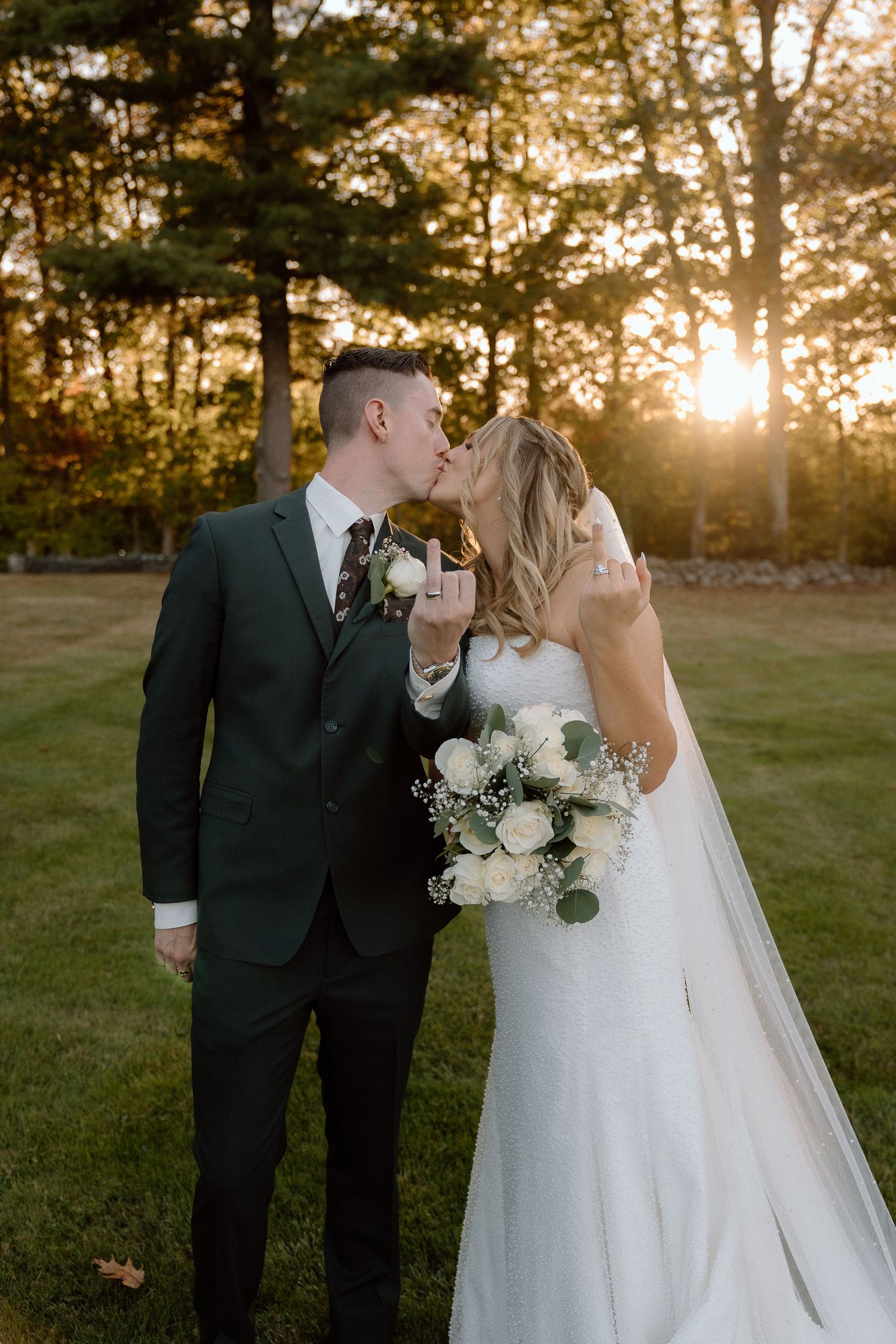 Sunset wedding portraits showing tender moments between couple with white floral bouquet.