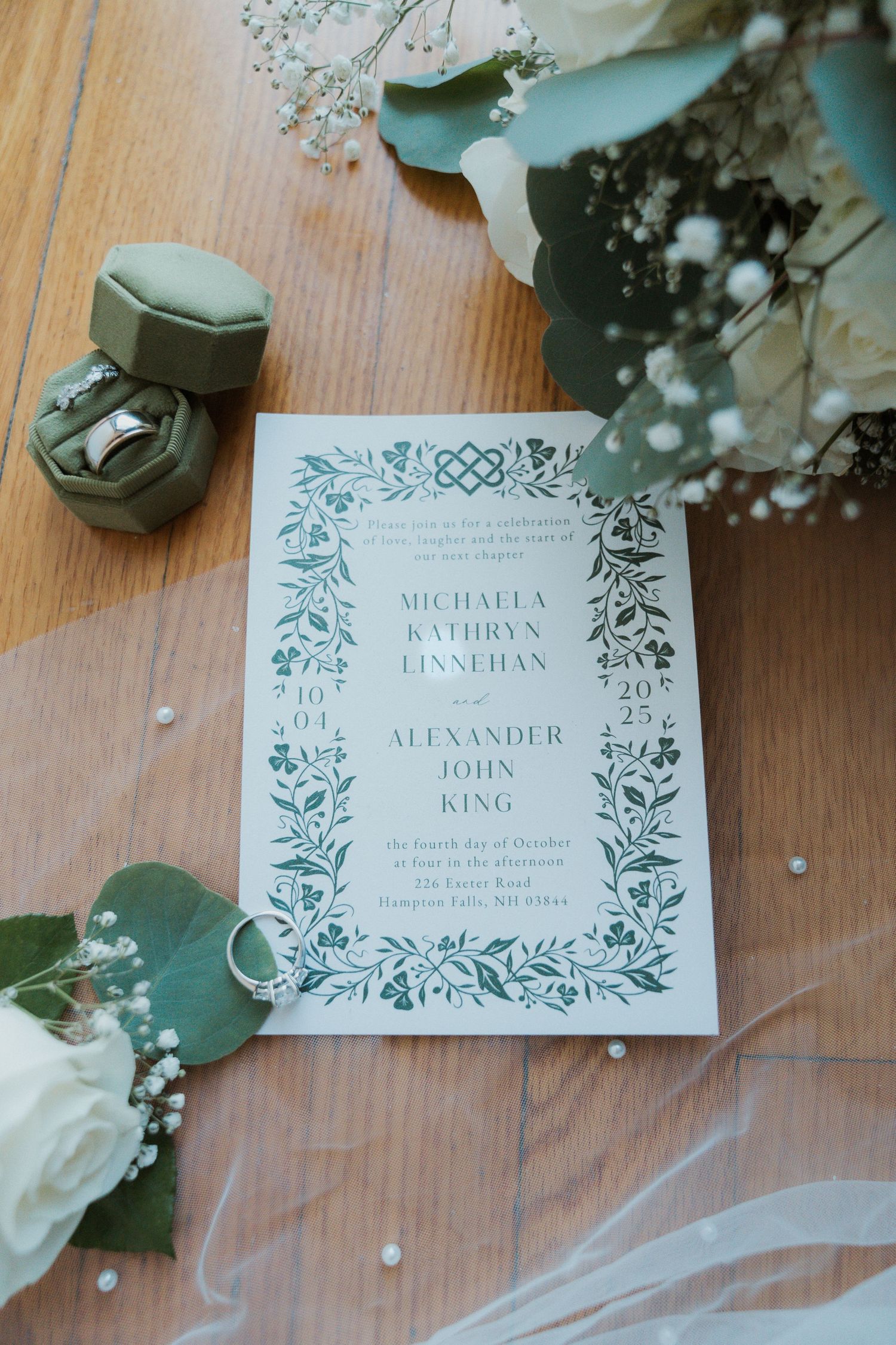 Wedding invitation detail shots with white roses and delicate floral border design.