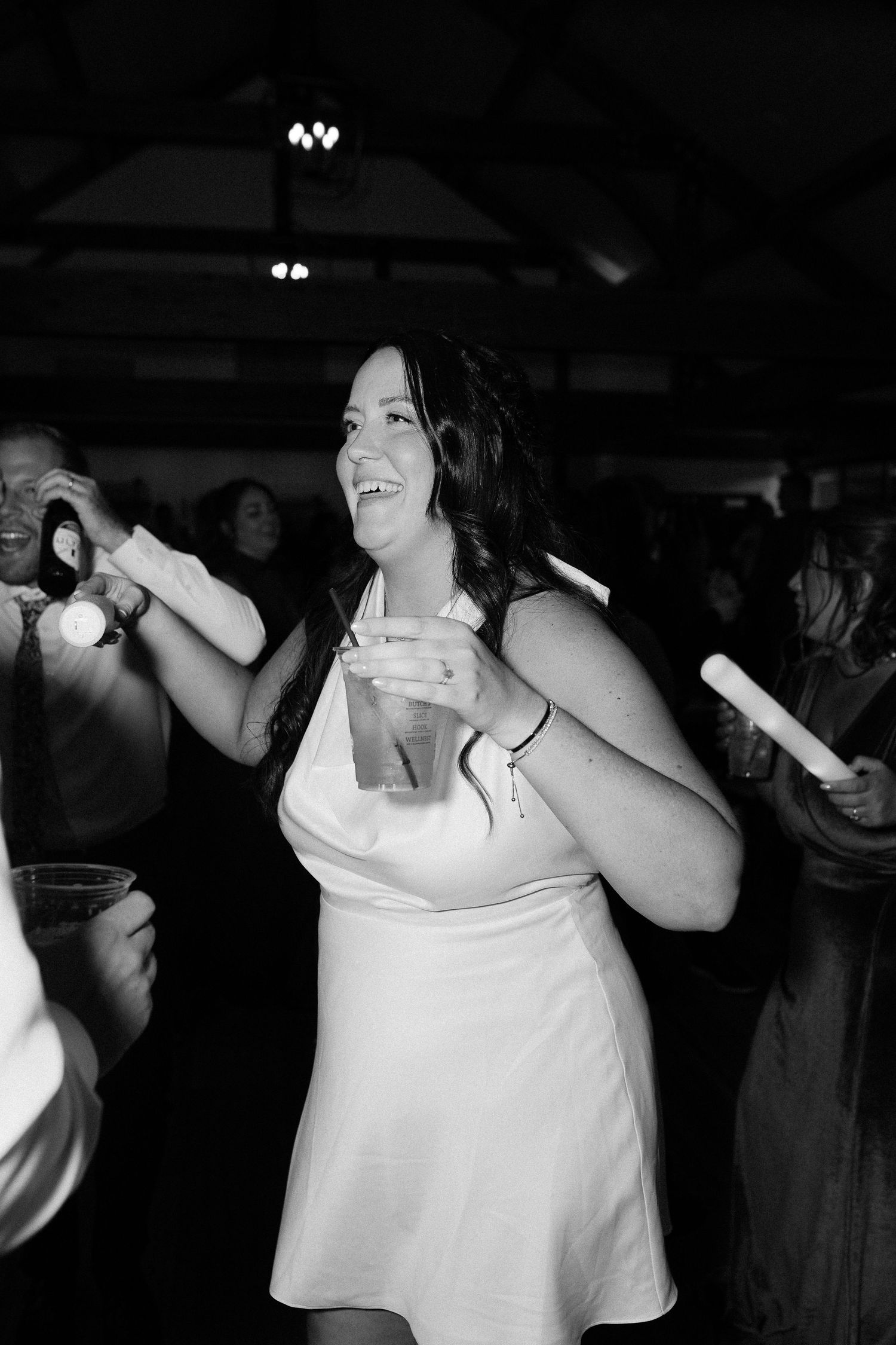 A joyful moment on the dance floor during a wedding reception with disco lights.