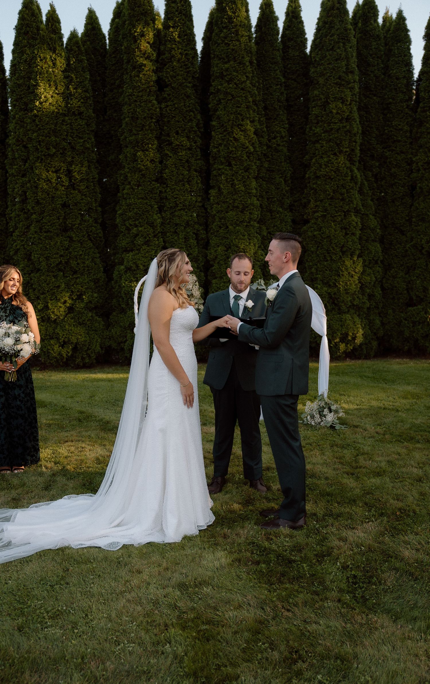 Wedding ceremony moments captured against elegant cypress tree backdrop during golden hour.