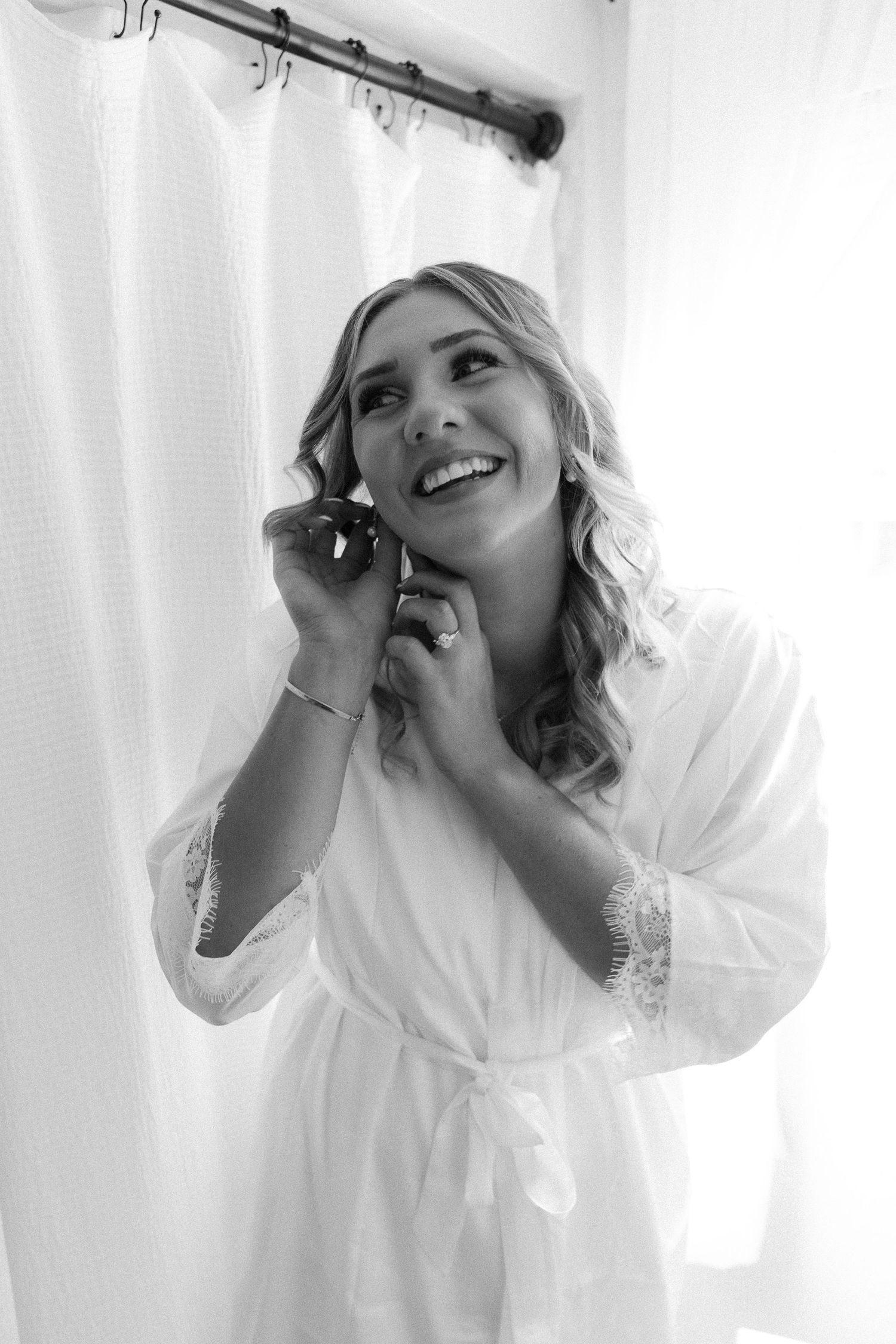 Candid moments captured of someone wearing a white robe while getting ready.