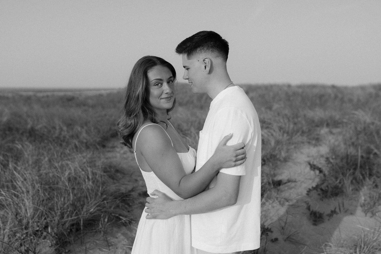 Black and white series showing tender moments between a couple on a natural outdoor setting.