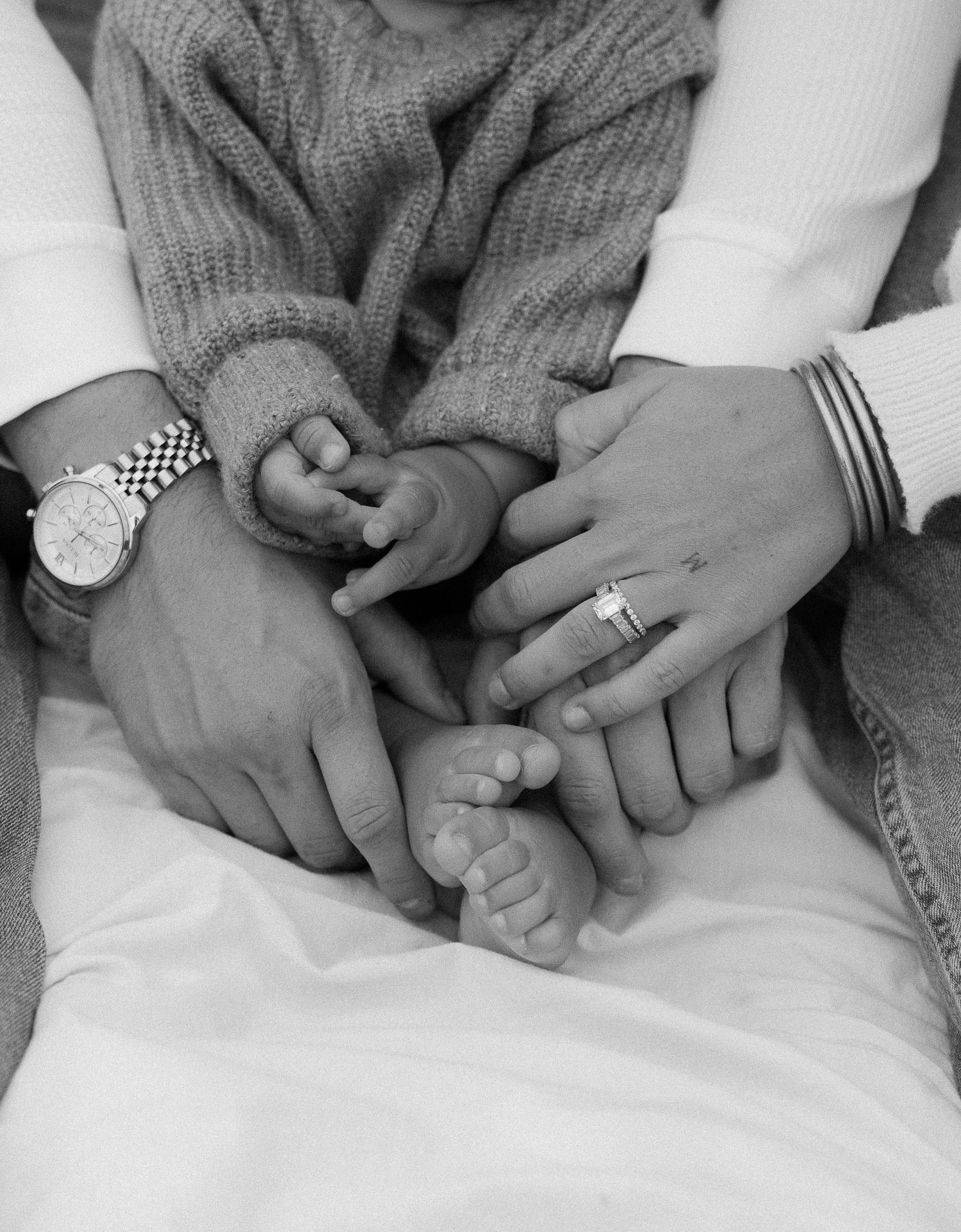 Black and white photo series showing hands tenderly clasped together in different intimate poses.