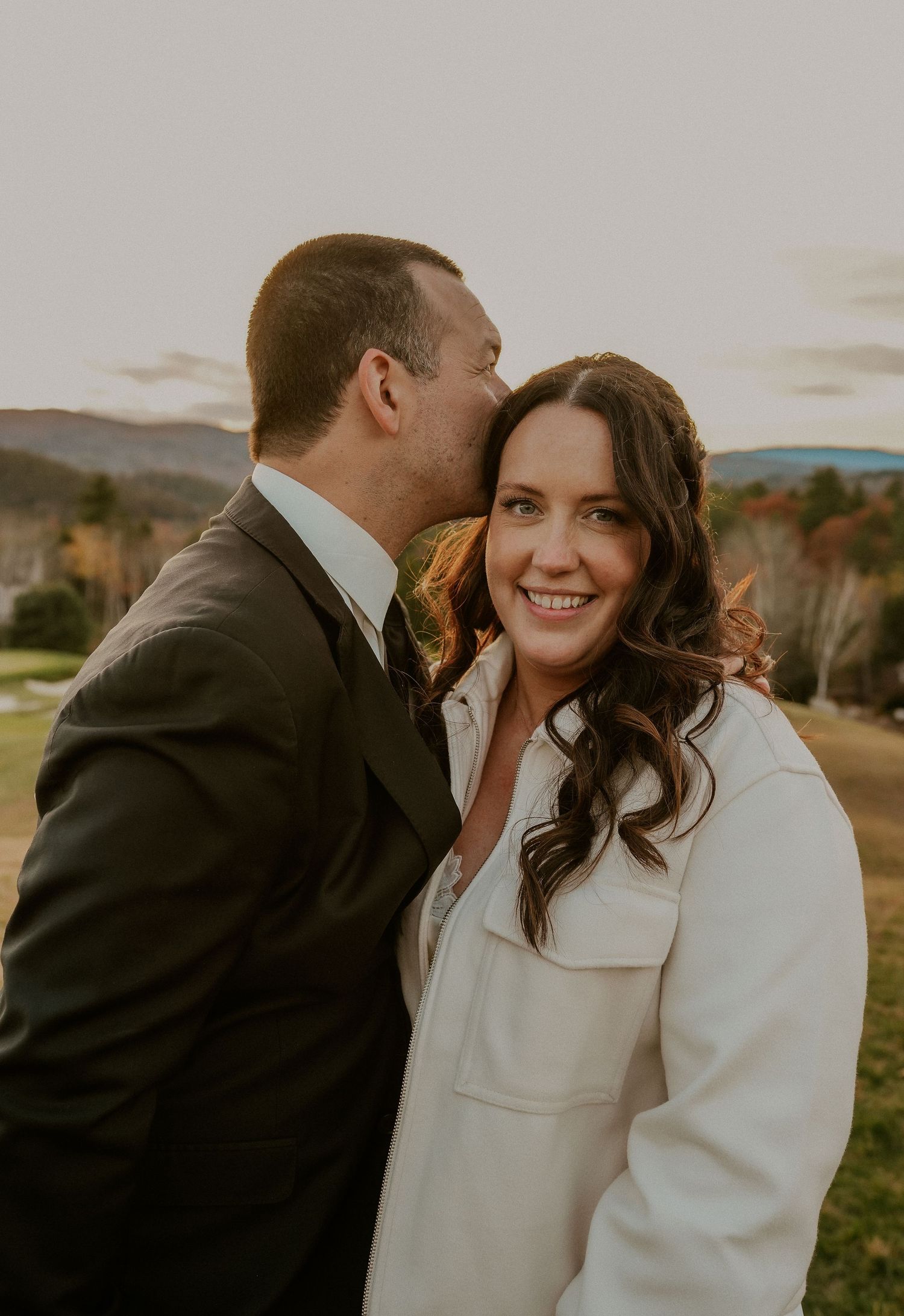Candid wedding portraits showing tender moments between newlyweds in winter outdoor setting.