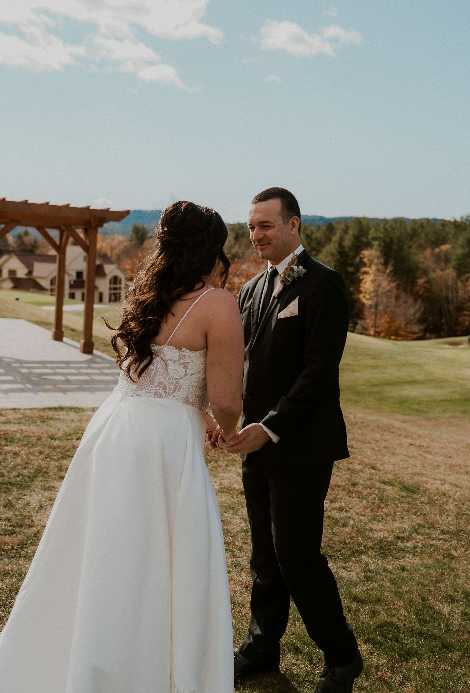 A romantic wedding photo sequence showing a couple dancing together on a grassy hillside with mountains in the background.