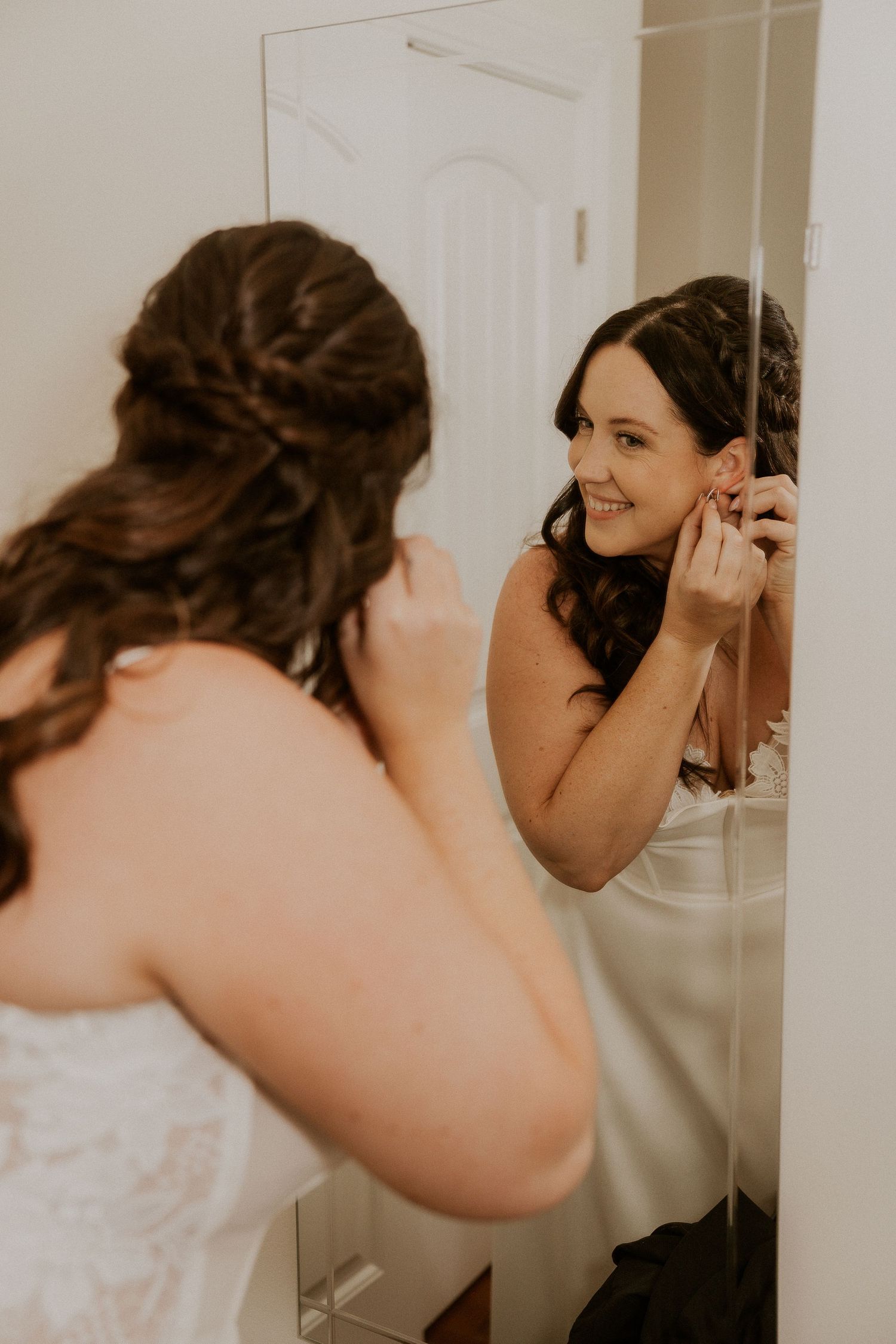 A sequence of photos shows someone putting on earrings while getting ready in a white room.