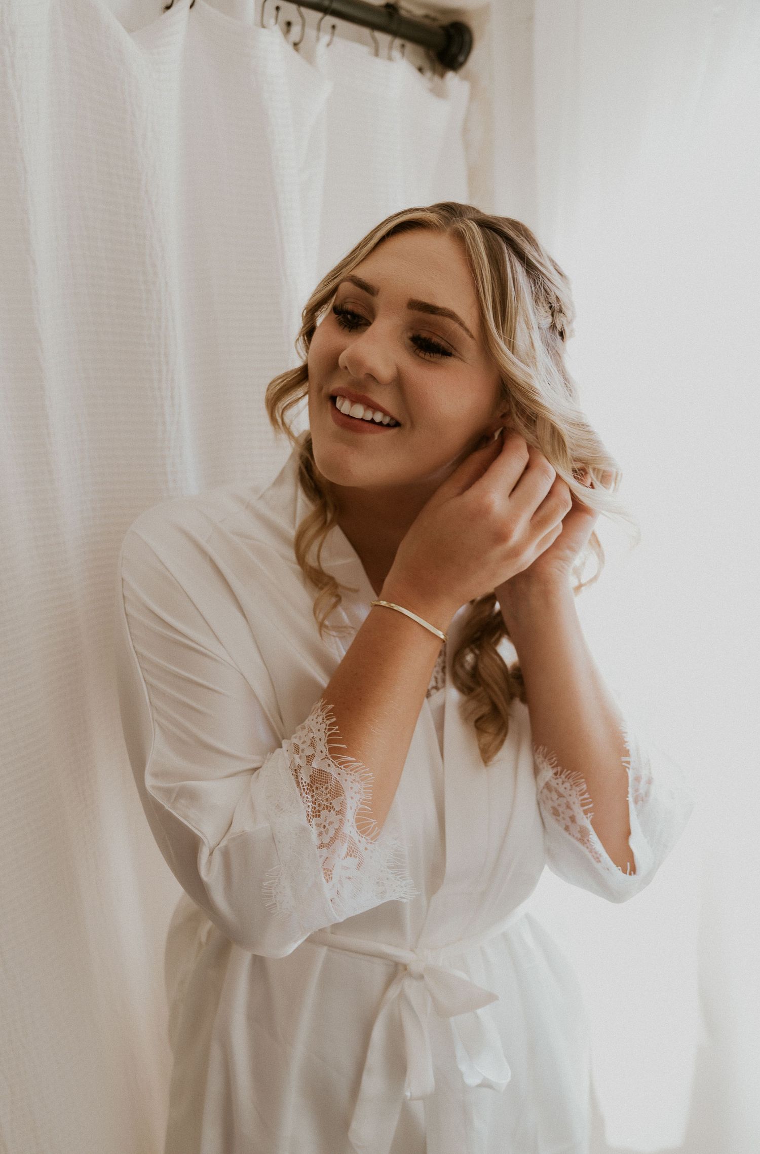 Close-up shots showing preparation moments in a white lace robe before a wedding.