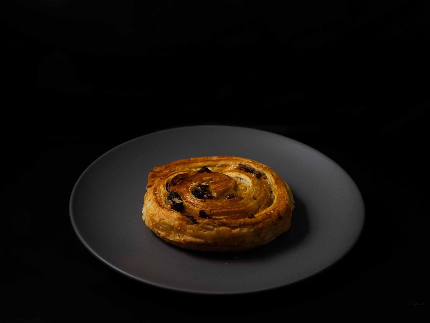 tasty pain au raisin captured by by Gerard Su Photography.