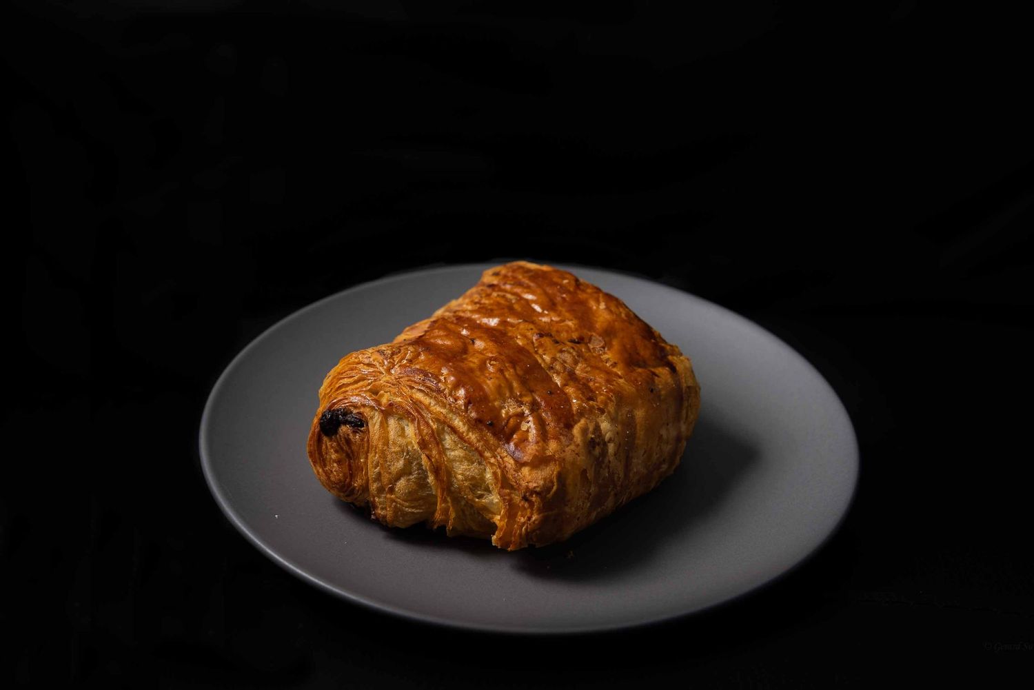 fresh pain au chocolat captured under studio lighting by Gerard Su Photography.