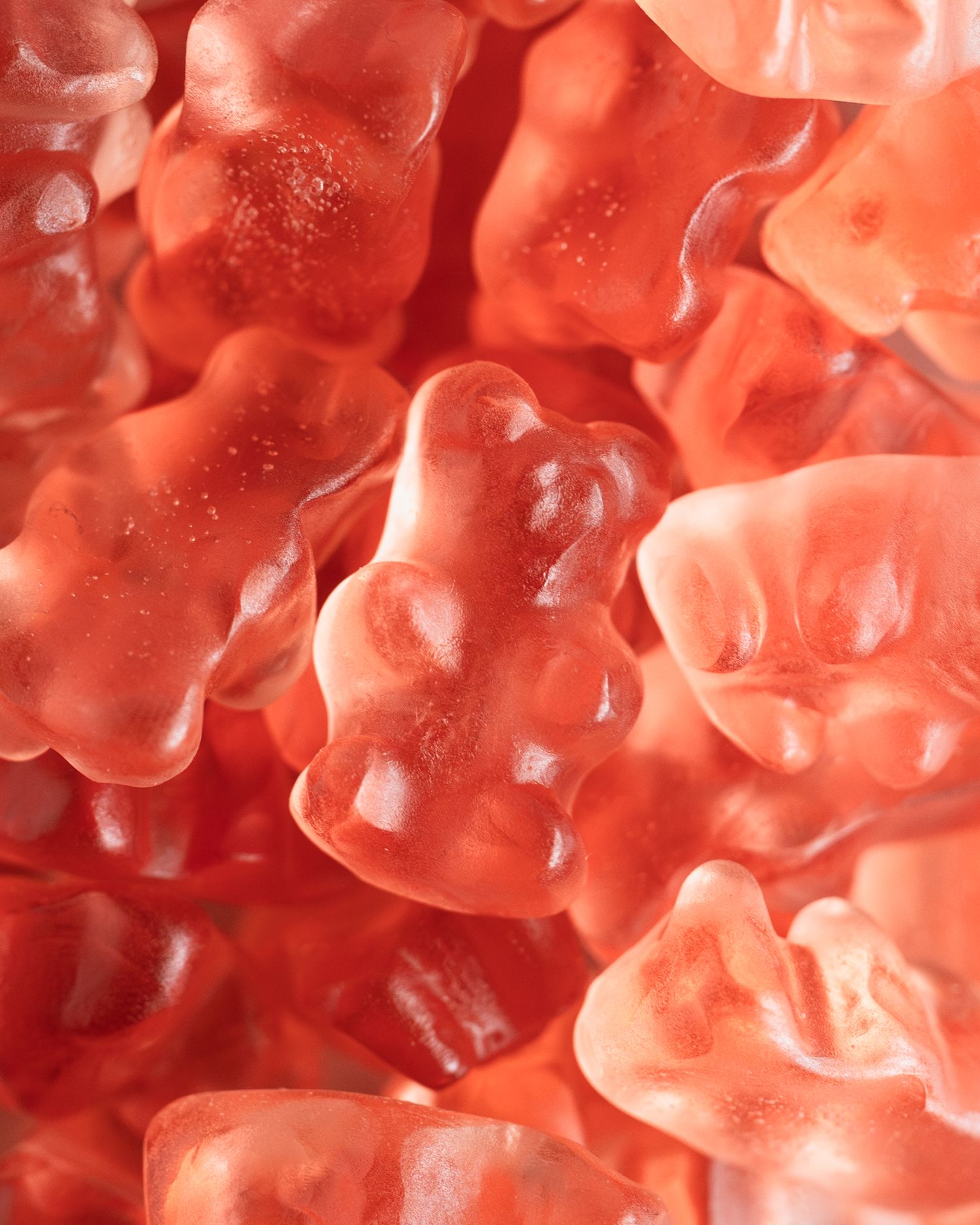 Close-up view of strawberry gummy bear candies with translucent texture