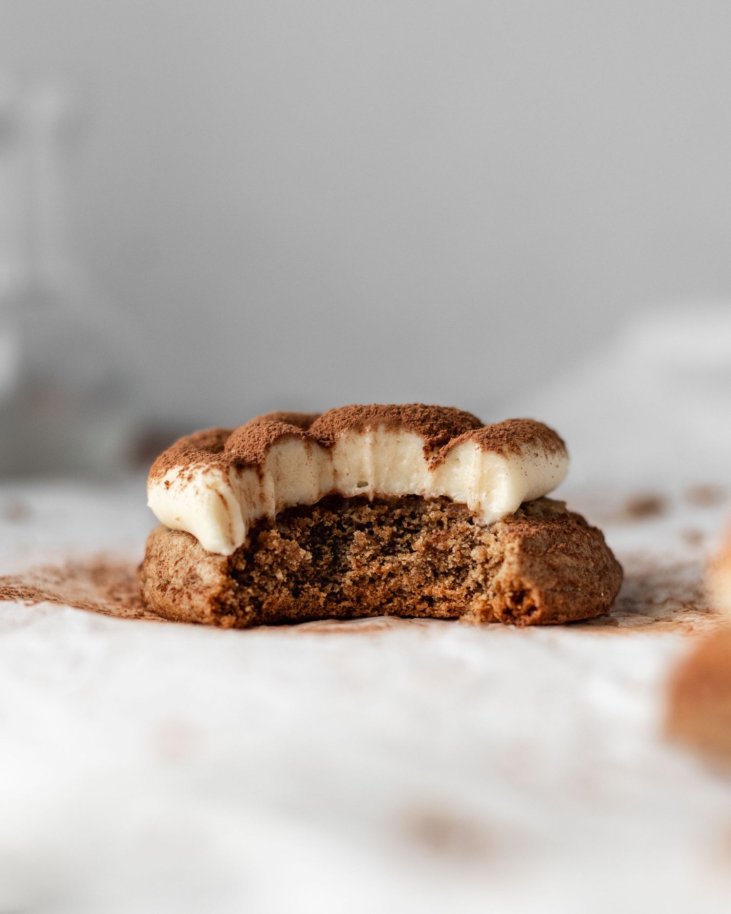 A homemade tiramisu cookie shown in a close-up side view.