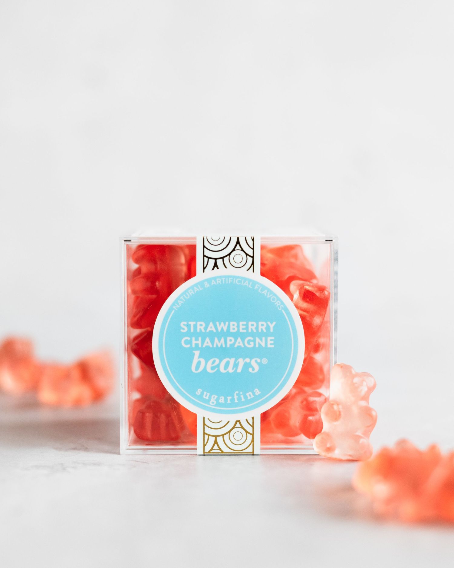Pink strawberry gummy bears displayed in a modern clear package against a light background.
