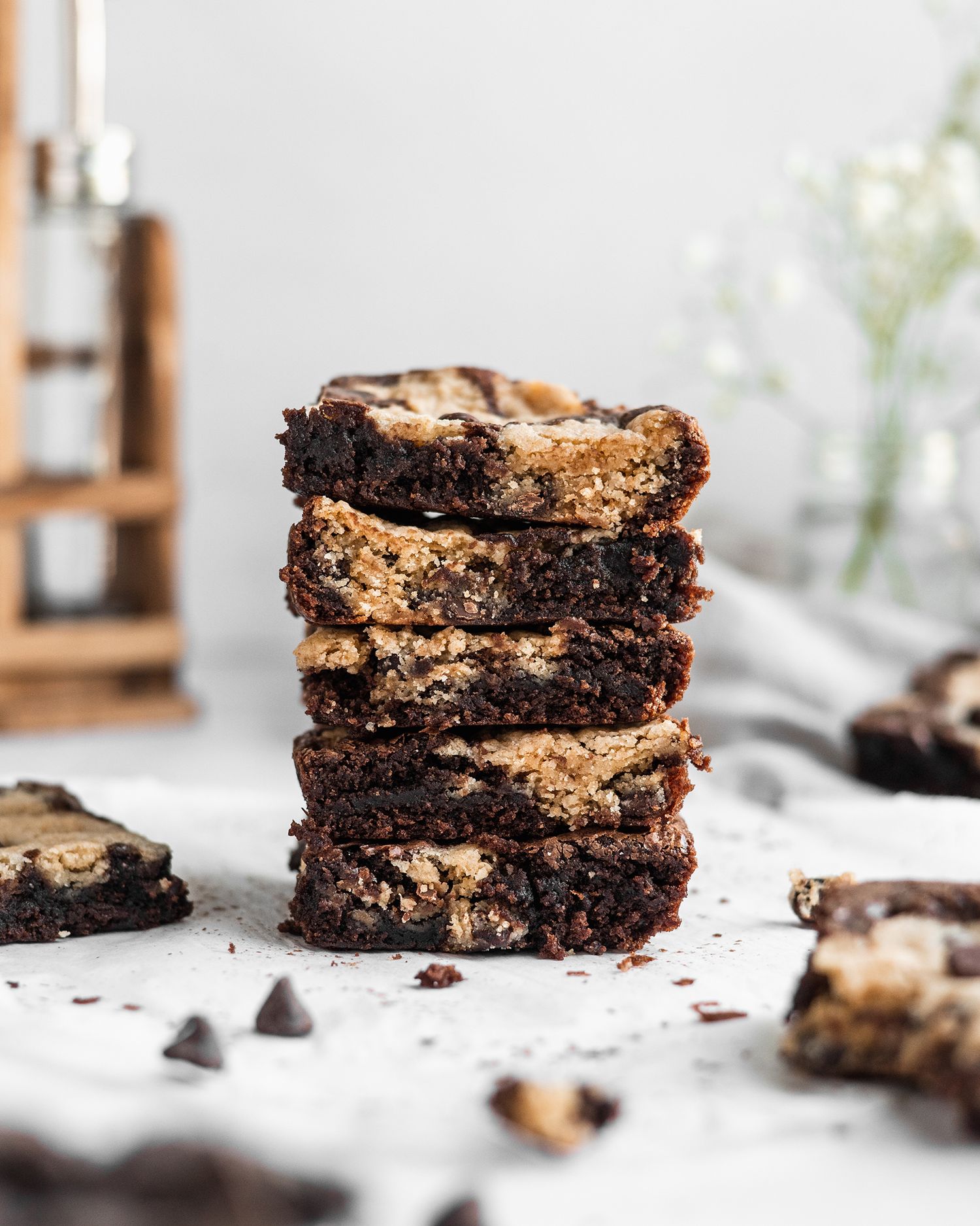Stack of homemade chocolate chunk brownies with crackly top crust.
