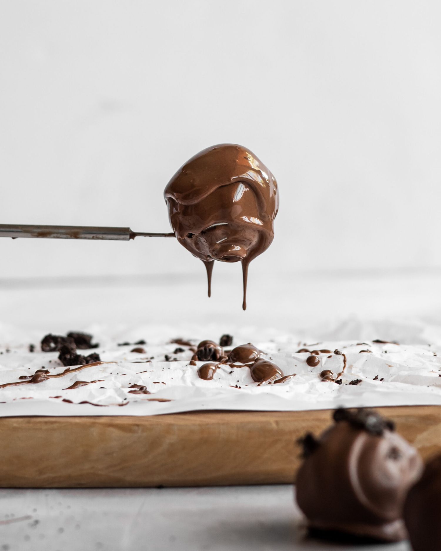 Chocolate drips and splashes artistically against a clean white background in a dynamic food photography sequence.