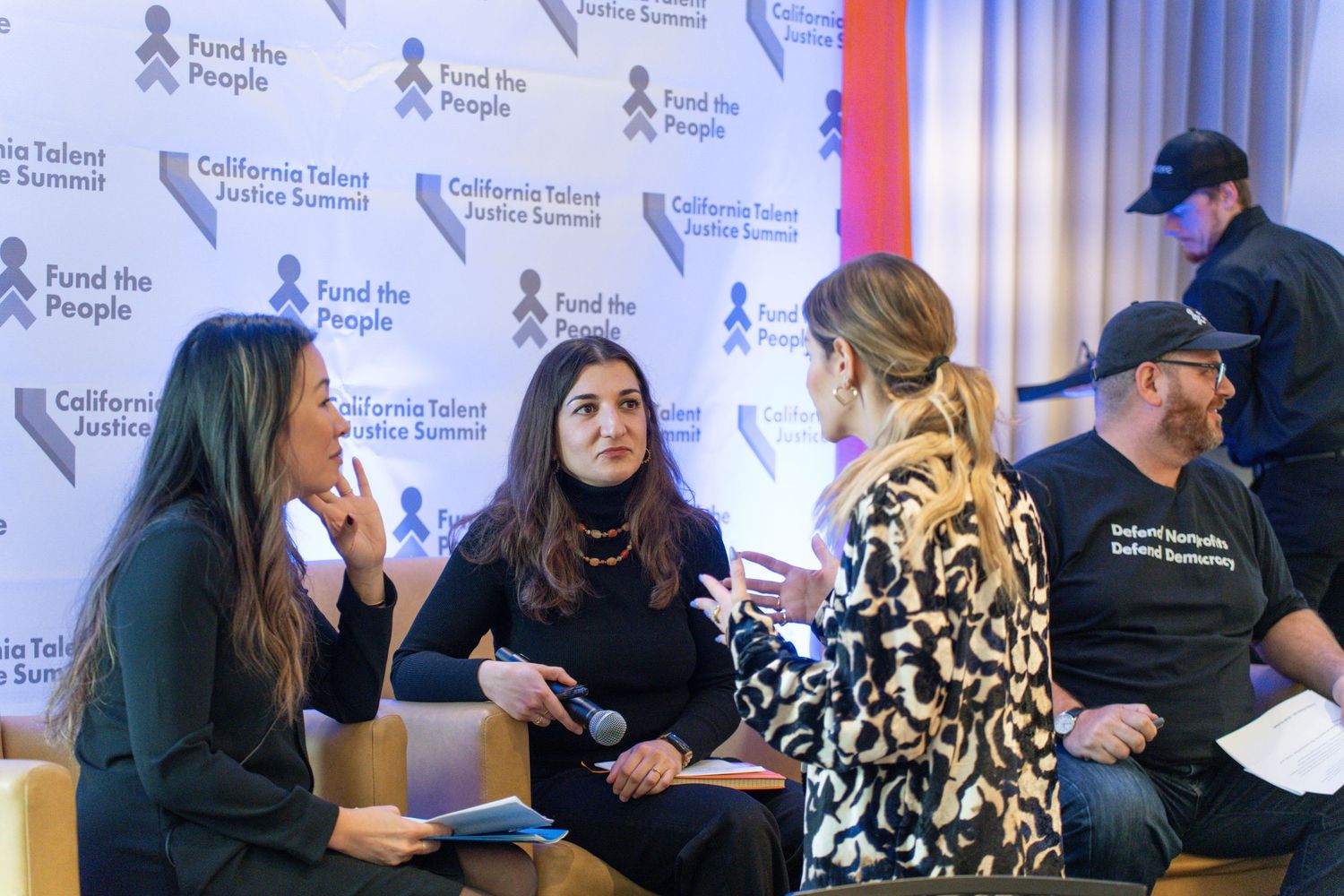 Conference attendees seated in rows at a professional networking event.