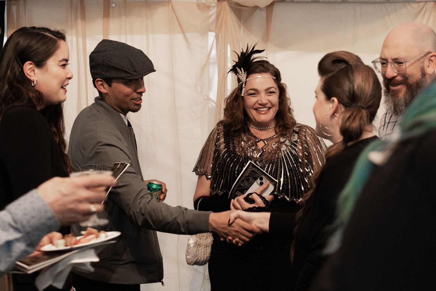 A group of people share a joyful moment at a social gathering.
