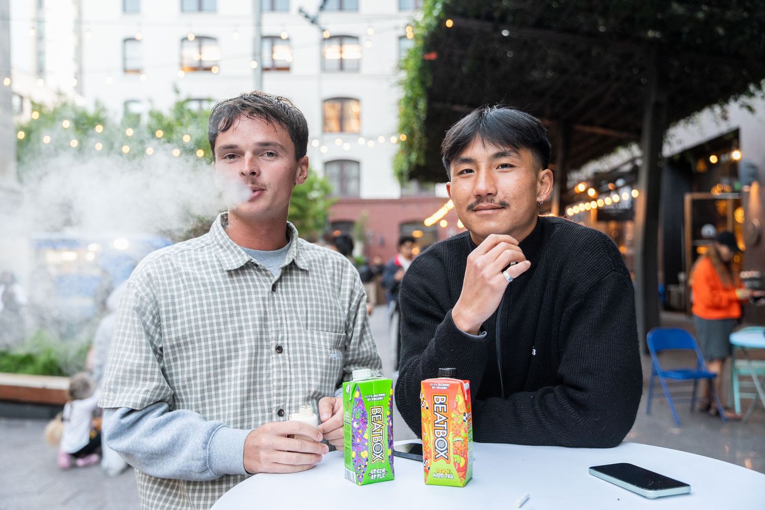 Friends enjoying drinks at an outdoor cafe patio.