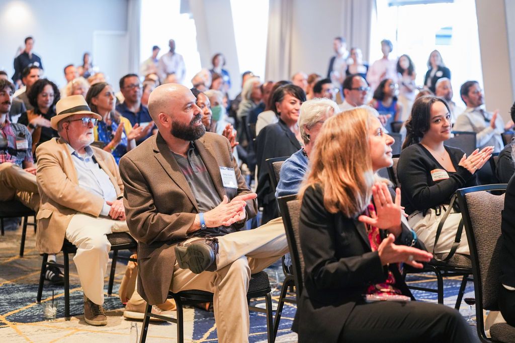 Attendees applaud during a presentation at the Berkeley Chamber of Commerce annual meeting, showing engagement and community support.