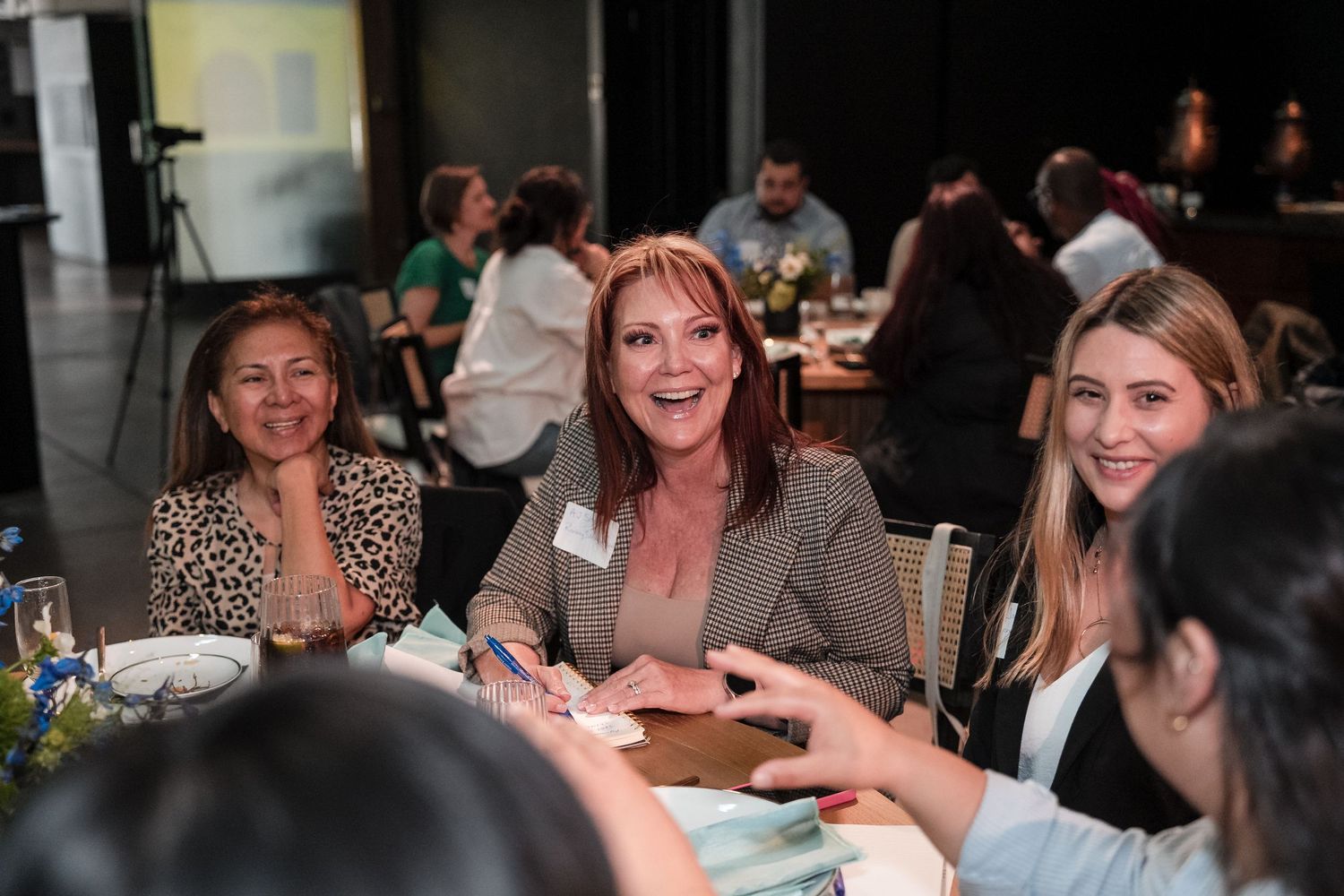 Attendees participate in an engaging roundtable discussion at a professional event.