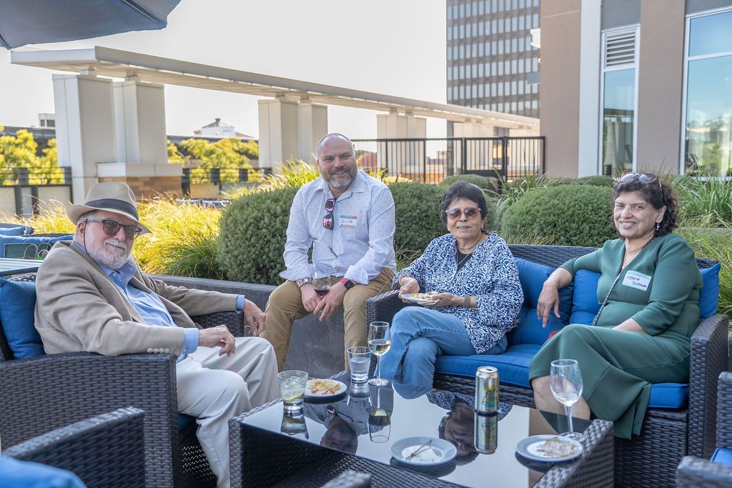 A small group of attendees relax on outdoor lounge seating, enjoying drinks and conversation at the Berkeley Chamber of Commerce annual meet