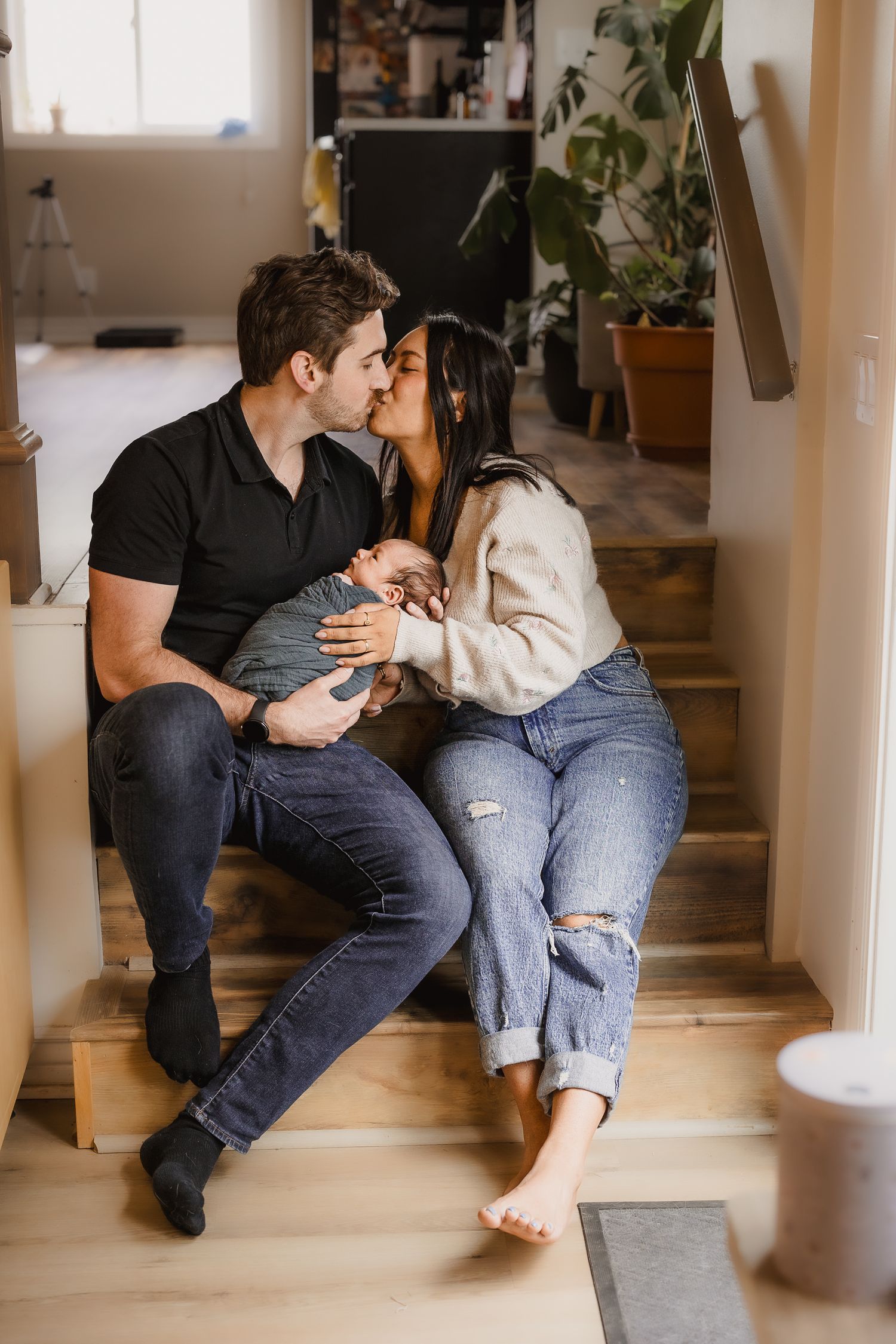 Intimate couples photography series showing cozy moments on indoor stairs.