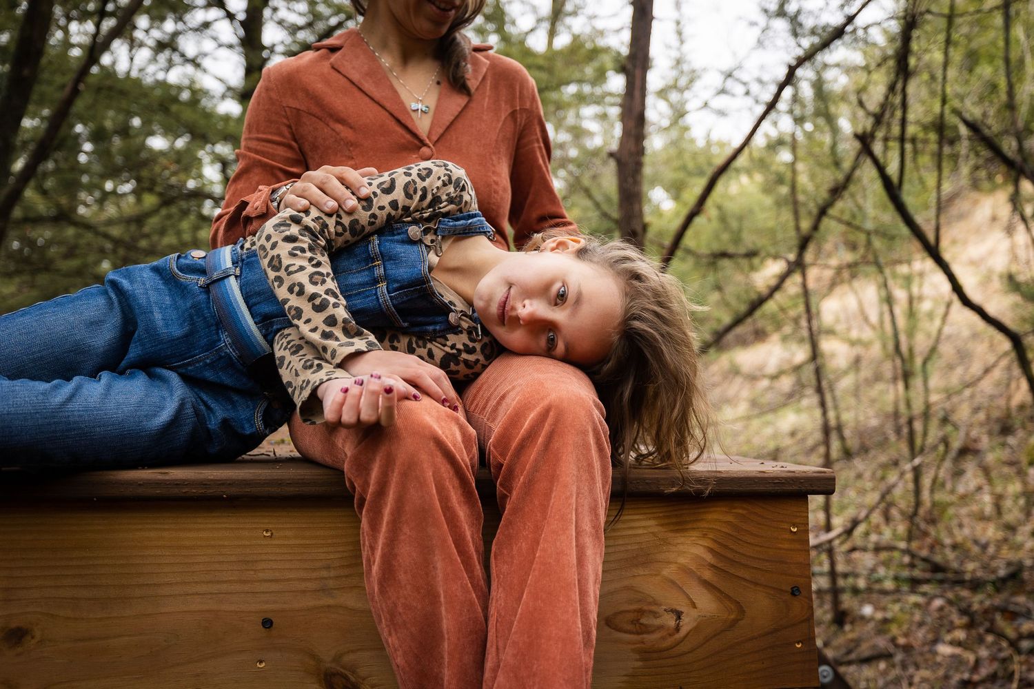 Casual outdoor family moments captured on wooden deck in natural setting.