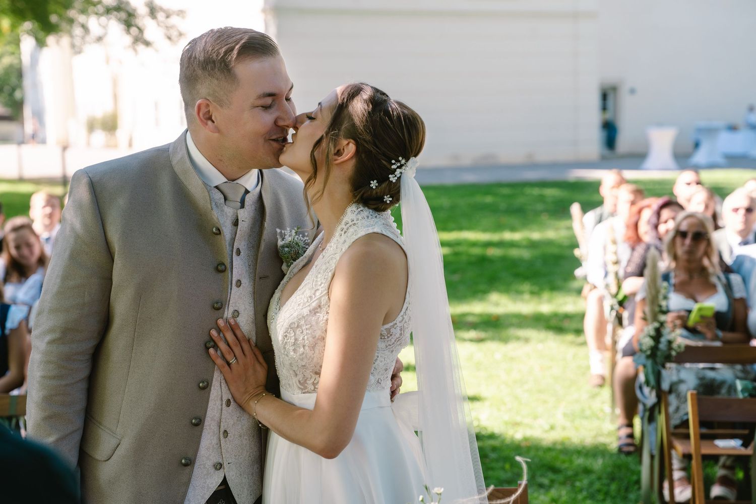 Intimate wedding ceremony moment shared between couple in a garden setting.
