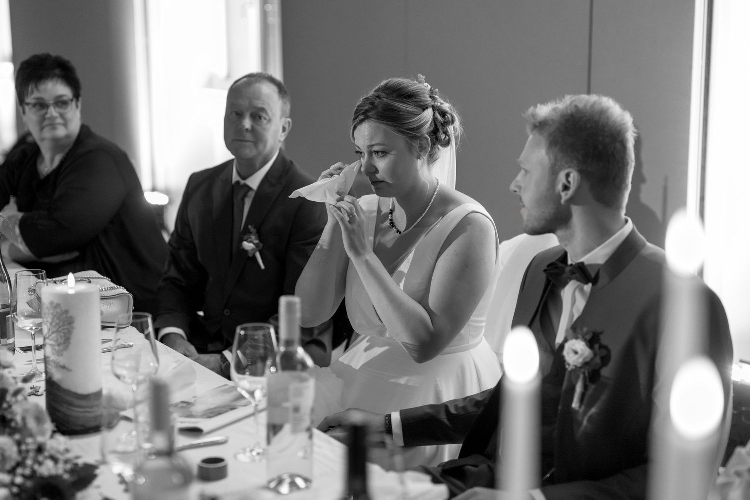 Black and white panorama of wedding reception guests seated at tables.