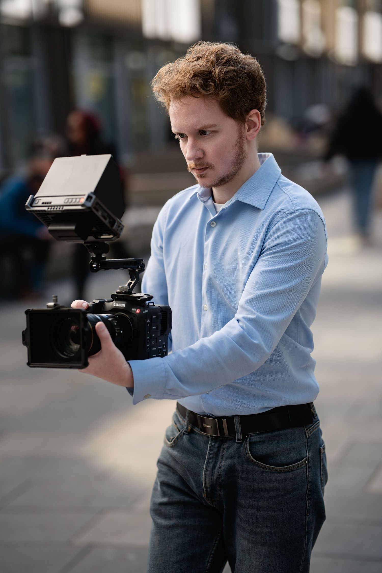Series of shots showing camera operation techniques with person wearing blue shirt and dark jeans.
