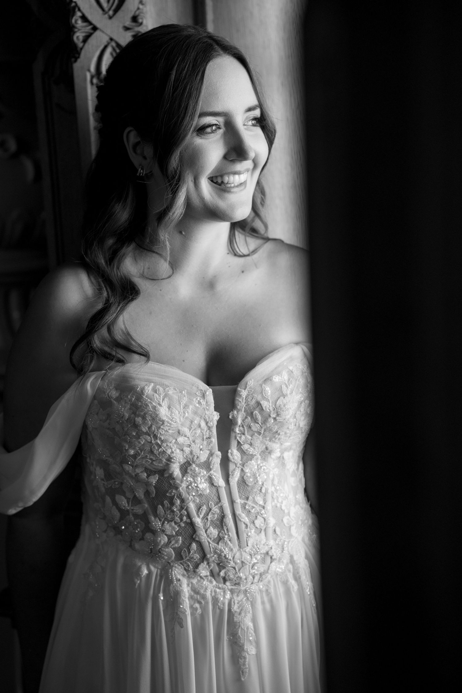 Dramatic black and white bridal portraits highlighting an elegant lace wedding dress.