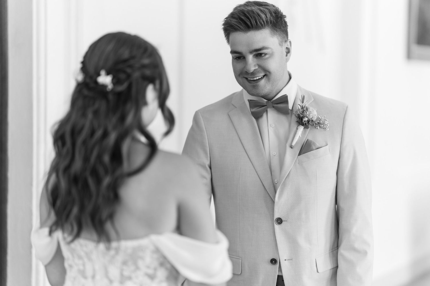 Wedding couple sharing a moment in bright indoor setting.