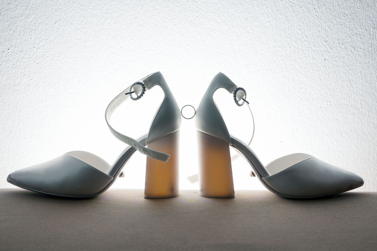 Elegant gray block heel sandals with ankle straps and wooden heels displayed back-to-back on a white surface.