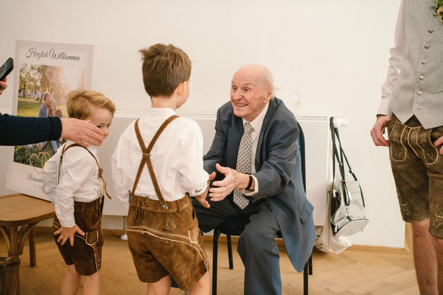 A series of candid gallery photos showing people viewing and discussing artwork at an exhibition opening.