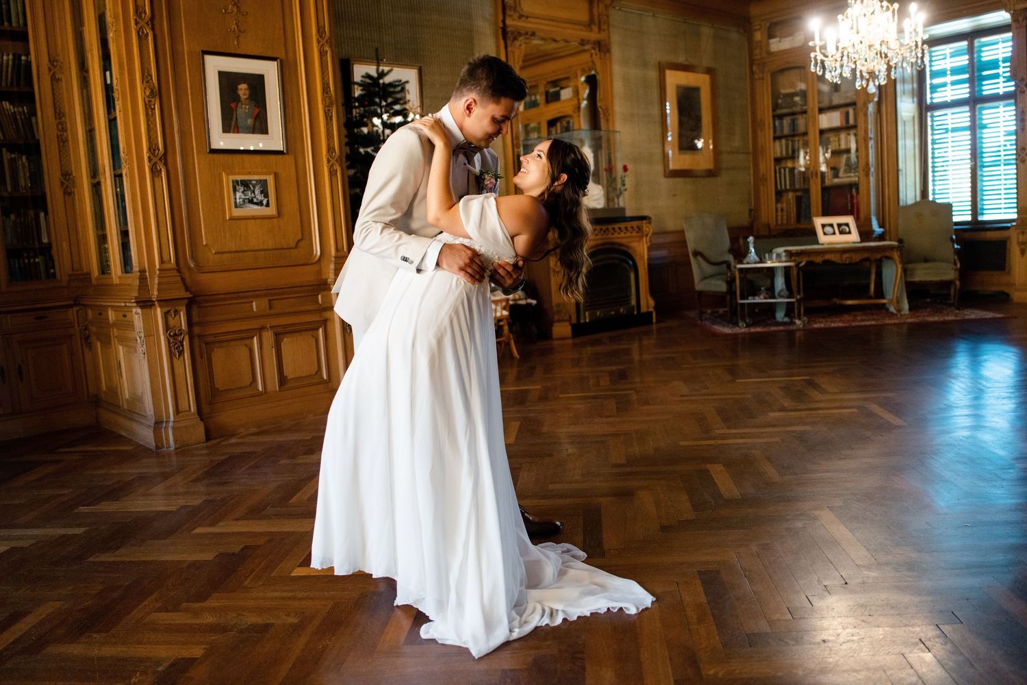 Romantic wedding photos in a dimly lit corridor with dramatic lighting effects.