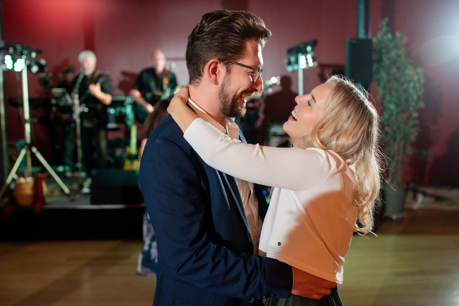 Couple sharing a romantic dance moment under atmospheric lighting.