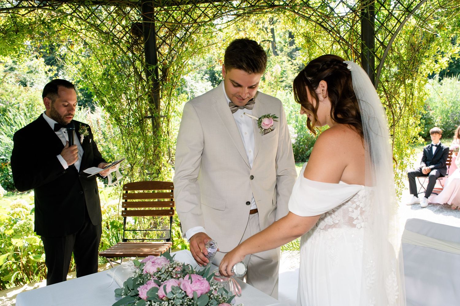 A couple shares an intimate moment during their outdoor garden wedding ceremony.