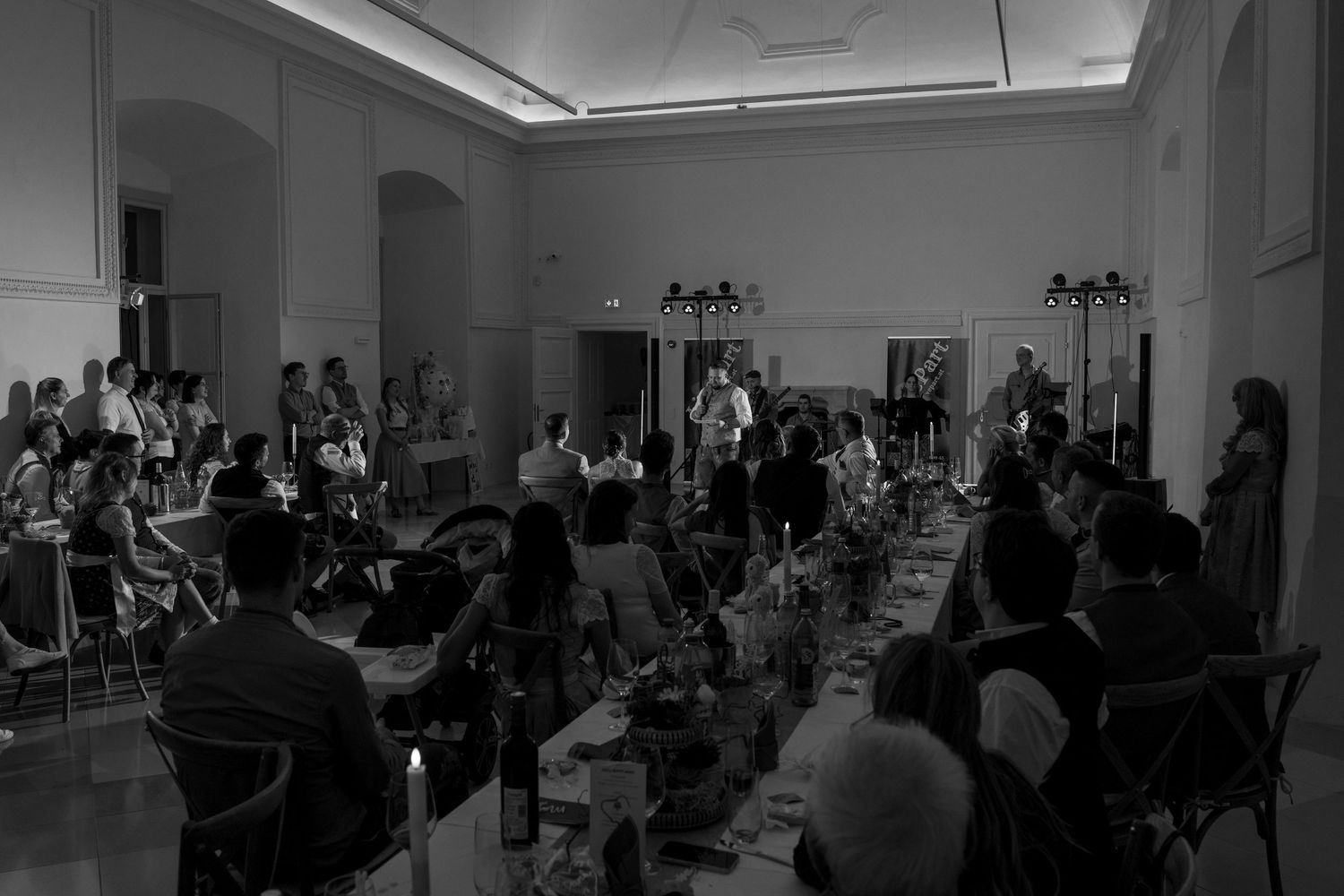 Wide shot of wedding reception venue with guests seated around the dance floor.