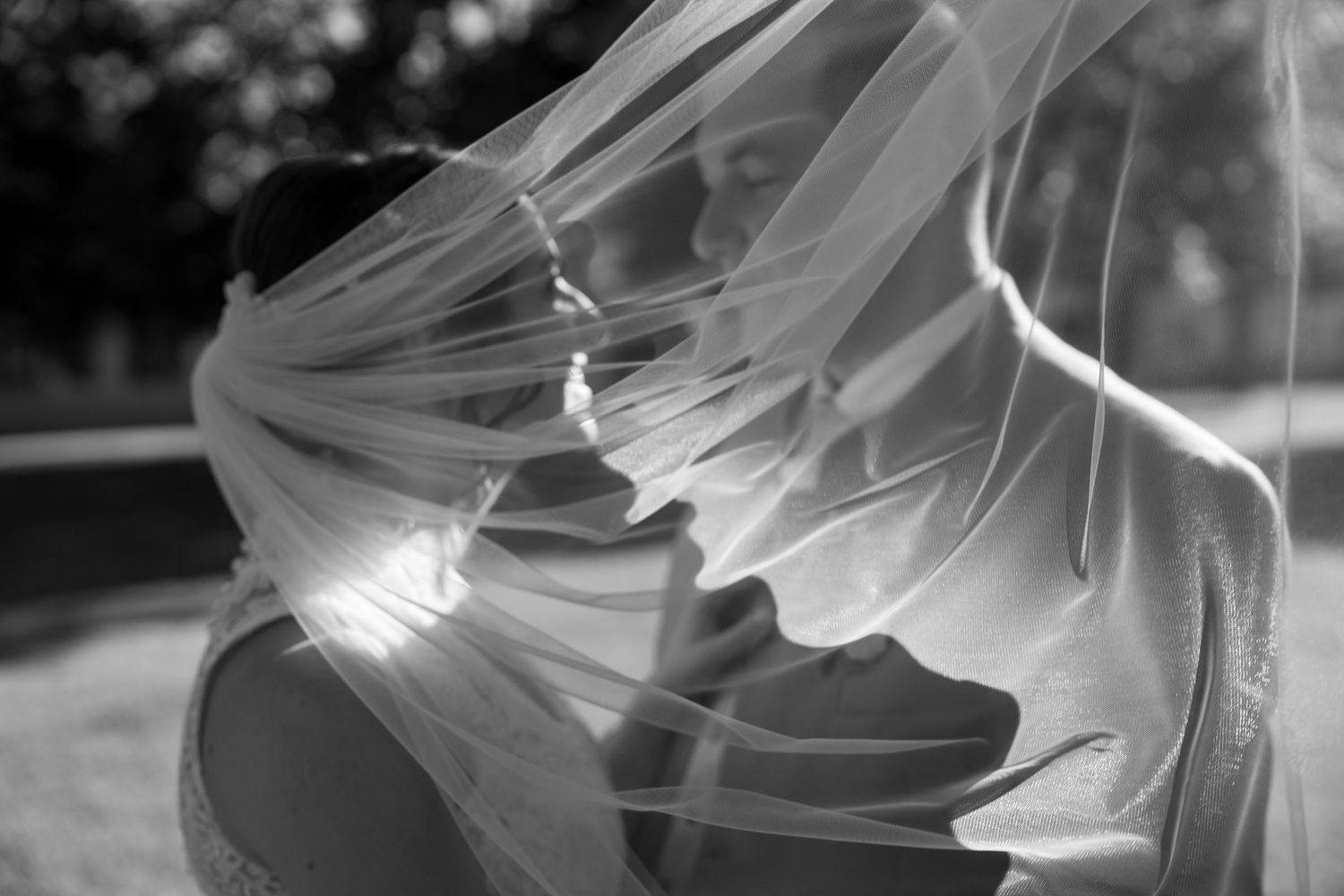 Artistic black and white close-up shots of flowing white fabric with dramatic lighting effects.