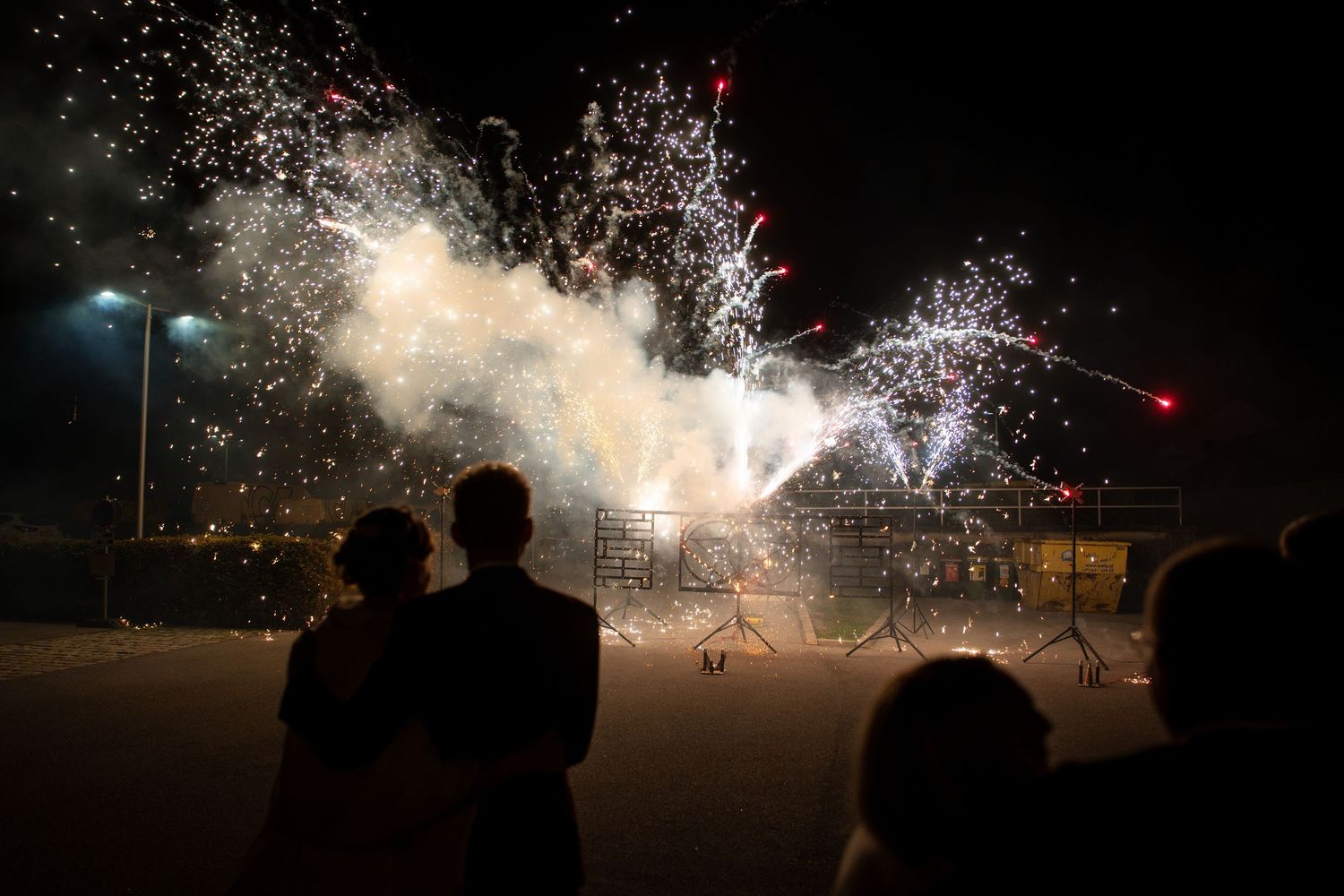 Bright fireworks display lighting up the night sky with sparks and trails.