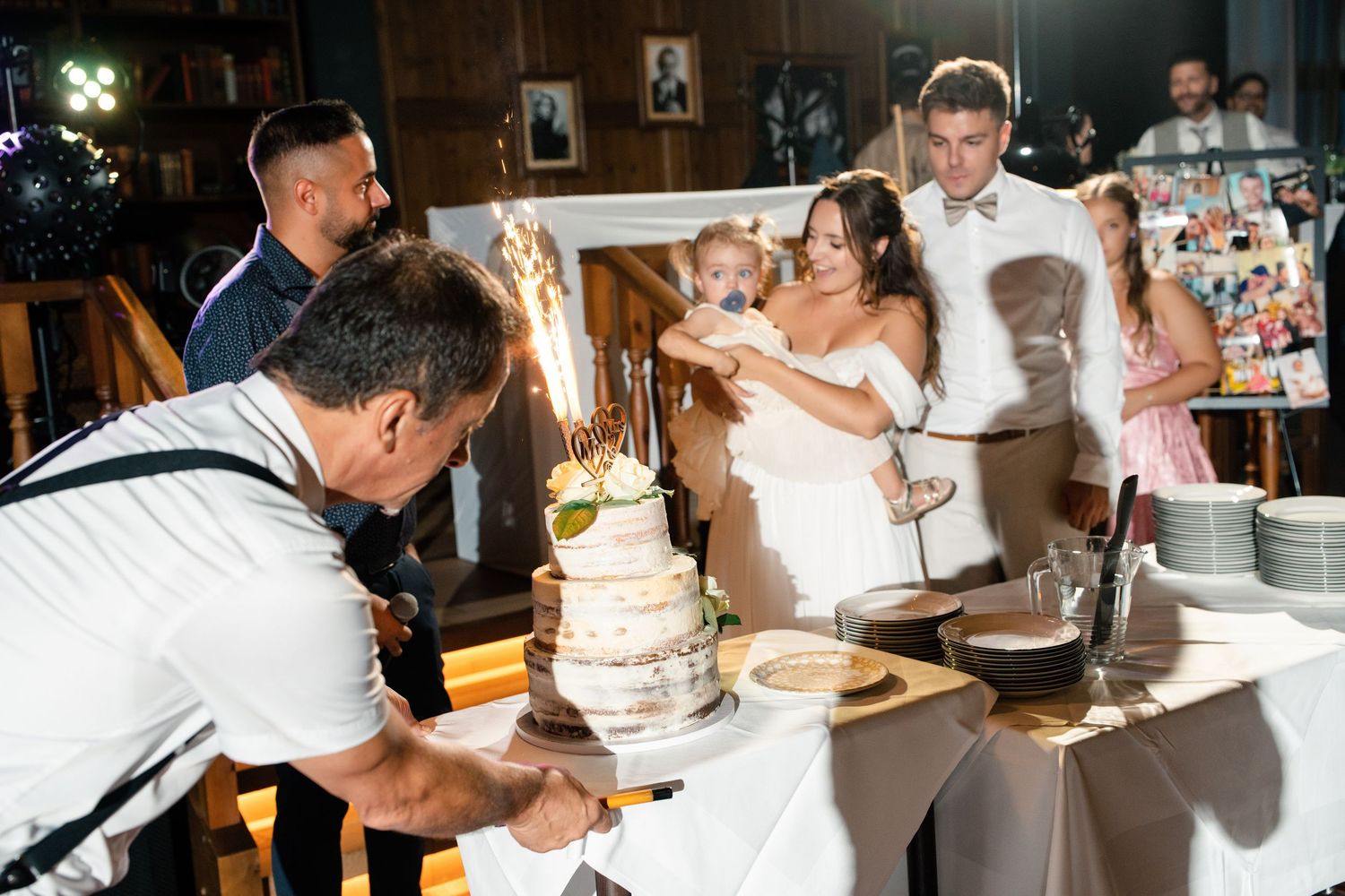 Wedding cake cutting ceremony with sparklers creating a magical atmosphere.
