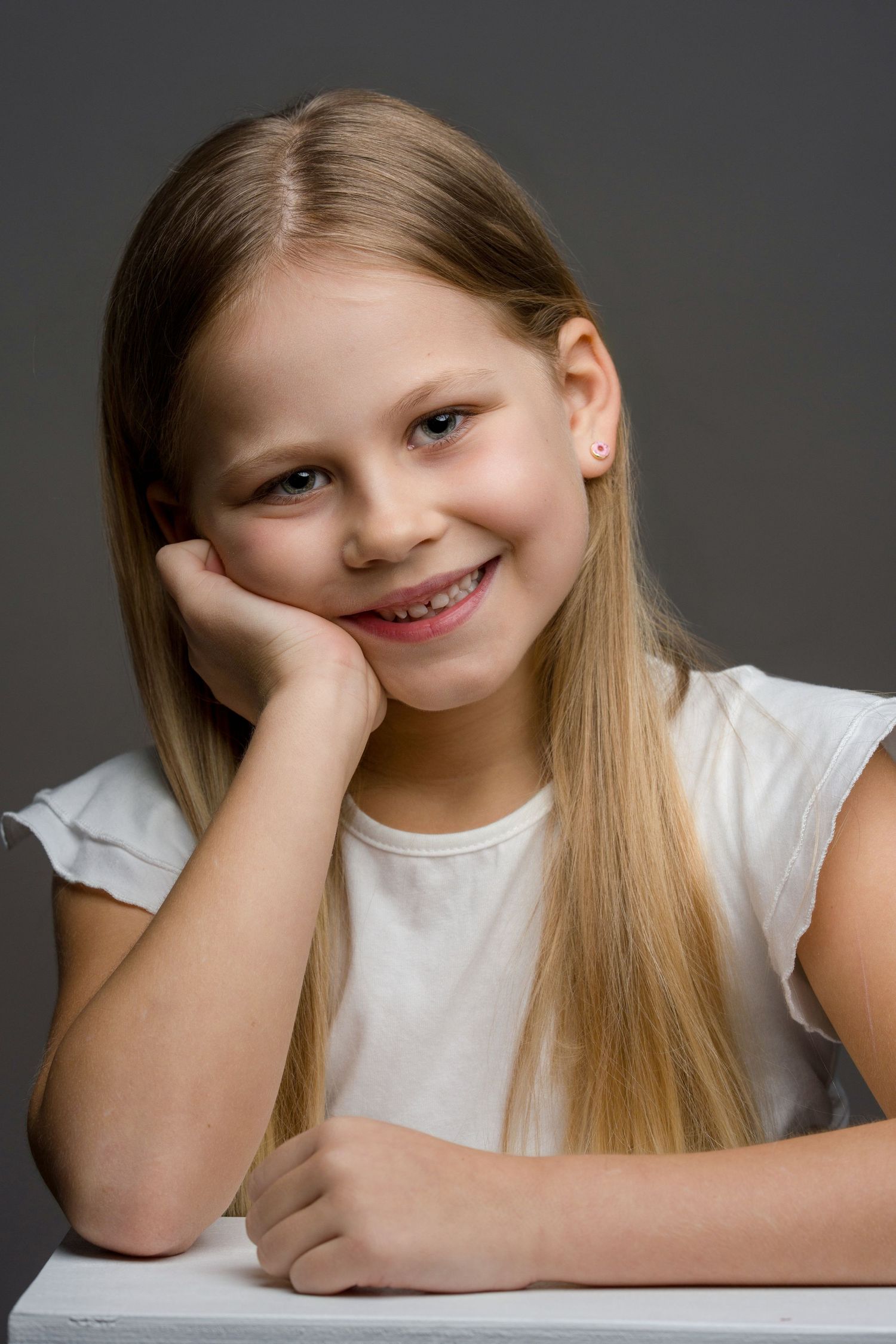A series of three photos showing a young person with long blonde hair wearing a white shirt resting their head on their hand.