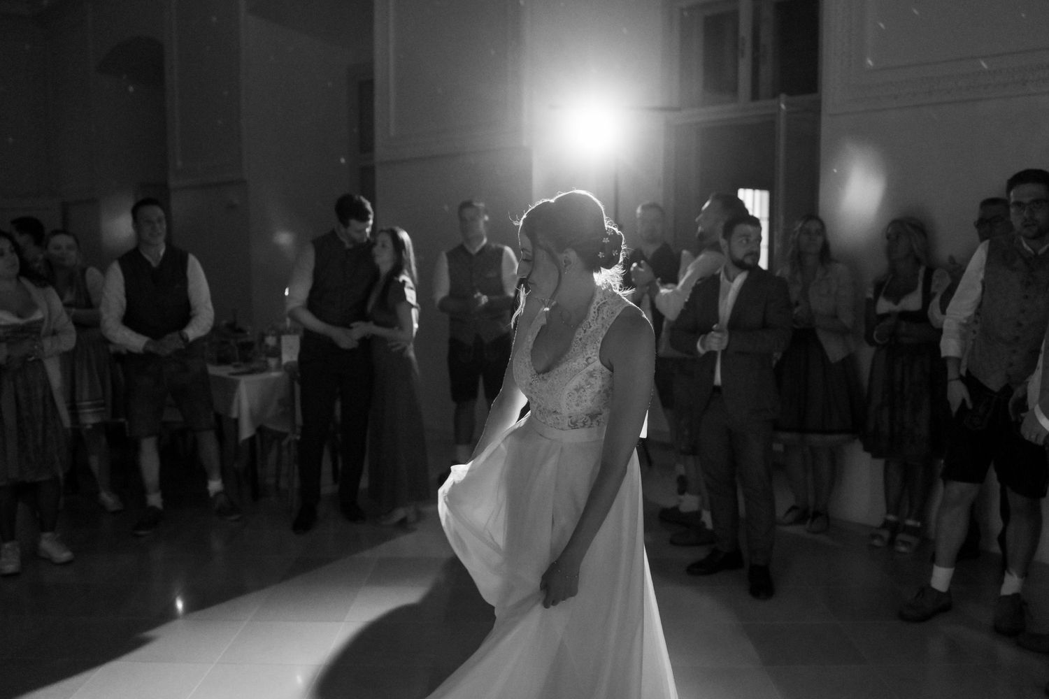 Wedding reception dance floor filled with celebratory moments in black and white.